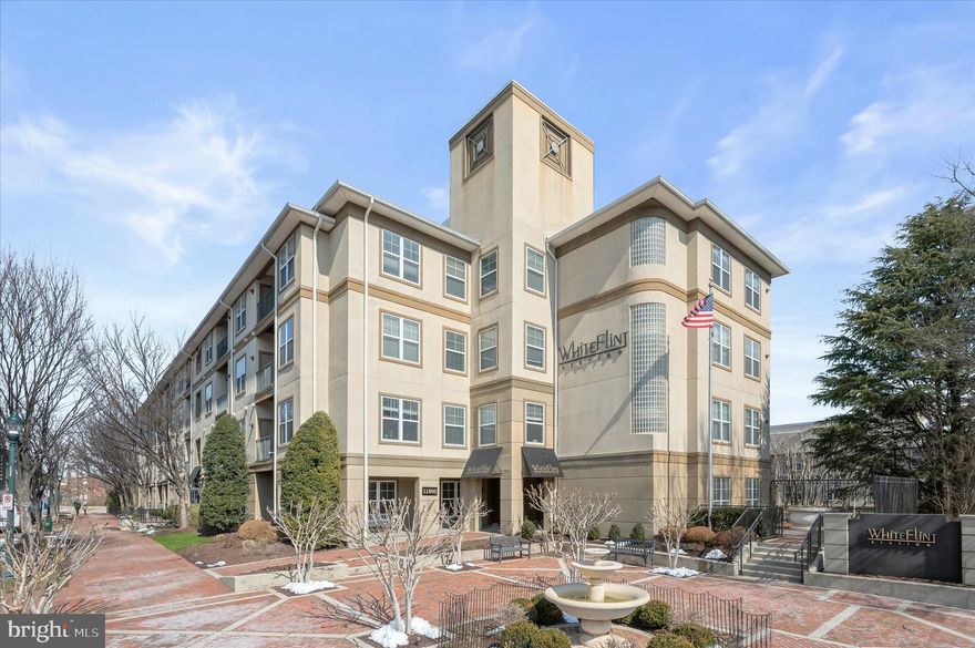 Welcome to this exceptional 3-bedroom, 2 full bathroom condo in the highly sought-after White Flint Station  Condominium Complex, in a highly desired North Bethesda location! Step into the inviting foyer and onto beautiful maple hardwood floors that flow seamlessly throughout the main living area. The space is enhanced by modern LED pendant lighting and upgraded soundproofed insulated ceiling — offering unmatched privacy and tranquility.
The kitchen is both stylish and functional, featuring maple cabinetry, granite countertops, a 5 Burner Oven Range gas cooktop and Charcoal stainless steel appliances, elegant pendant lighting, tile backsplash and breakfast bar. The large flat-75" screen TV and sound bar convey in the living room convey with the property, making this home truly move-in ready.
Just off the main living area, the spacious primary suite is separated from the secondary bedrooms for added privacy. The suite boasts a luxurious, fully renovated marble shower, double vanity, walk-in close significant built in shelving and storage bins, heated towel rack and an upgraded Kohler bidet toilet for added comfort.
Down the hallway, you’ll find two generously sized secondary bedrooms both filled with natural light, one featuring  a walk-in closet The second full bathroom is spacious and also includes an updated Kohler toilet/bidet, maple vanity w/granite top, and soaking tub/ shower combo. The laundry room boasts high efficiency washer and dryers , built in storage cabinets and motion detector lighting. A significant recent upgrade was a built in surge detector
A SIGNIFICANT differentiating and HIGHLY convenient feature is the 2 car DEEDED to the property parking spaces located just steps away from the front door entrance to the unit. A storage UNIT#150 in Room 15 is located in the "B" entrance.
Beyond the unit, the building offers an impressive array of amenities, including an outdoor pool, well equipped fitness center, expansive common areas, dedicated workspace business center, impressionable marble reception area and luxurious lounge area. A dramatic marble descending staircase ushers you and your guests to a huge Additional recreation area with a magnificent coffered ceiling, billiards table and a grand fireplace as the central focus in the roam for cozy relaxing over drinks, food, a great book or games. An adjacent bar with overhead  wall mounted TV rounds out your lounging experience.
The location is unbeatable — just 0.3 miles to the metro and steps from Pike & Rose, one of the area’s premier destinations for shopping, dining, and coffee shops. Enjoy the blend of comfort and accessibility!
Showings will begin on Saturday at 9am.