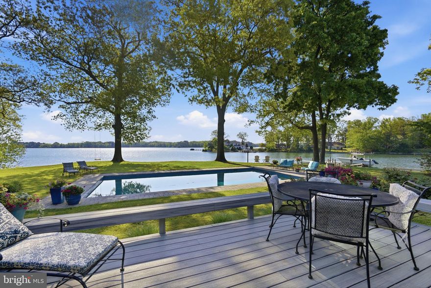 Welcome to “This is Wye”! Set on a spectacular elevated lot overlooking the Wye River, this Exceptional property captures breathtaking views of both the river and Wye Island. This beautifully designed one-level residence offers 3 bedrooms and 3.5 baths, delivering effortless waterfront living with a refined, thoughtful layout. Completely renovated in 2018 and enhanced with ongoing updates through 2026, the home features hardwood flooring throughout, along with abundant windows and skylights that fill the interiors with natural light and showcase expansive water views from nearly every room.
The renovated gourmet eat-in kitchen is both stylish and functional, equipped with top-of-the-line appliances, a generous center island, convenient mudroom, and seamless flow into the main living spaces. The living room opens naturally to the dining area and is anchored by a wood-burning stove insert, creating a warm and inviting focal point. A separate yet connected family room provides additional gathering space, and both rooms feature sliding glass doors that lead to the waterside patio, pool, and deck—ideal for indoor-outdoor living.
The primary suite is a private retreat, set in its own wing and thoughtfully appointed with dual walk-in closets and two en suite baths. One bath features a double-sink vanity, soaking tub, and glass-enclosed shower, while the second offers a single-sink vanity and glass-enclosed shower. Two additional bedrooms share a well-designed Jack-and-Jill bath, and a charming powder room completes the interior.
Outdoors, the property is equally impressive, with a waterside gunite pool, expansive decking, and approximately 450 feet of bulkheaded shoreline. The new protected pier offers 5+'MLW and includes a lift, three slips, and a floating dock, making it ideal for boating enthusiasts.
A detached, oversized garage, connected by a breezeway, includes a spacious office and workshop, while two additional storage sheds provide ample space for equipment and tools. Mature landscaping, trees, and extensive hardscaping create a private, picturesque setting.
Recent improvements include the renovated kitchen and baths, refurbished pool, Andersen windows and doors, encapsulated crawlspace, generator, and tankless water heater and so much more—offering a truly turnkey waterfront lifestyle.