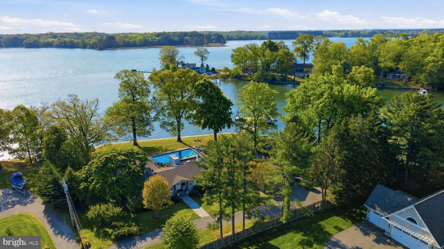 *Professional photos Coming.  Welcome to “This is Wye”! Set on a spectacular elevated lot along the Wye River, this exceptional property captures breathtaking views of both the river and Wye Island. This beautifully designed one-level residence offers 3 bedrooms and 3.5 baths, delivering effortless waterfront living with a refined, thoughtful layout. Completely renovated in 2018 and enhanced with ongoing updates through 2026, the home features hardwood flooring throughout, along with abundant windows and skylights that fill the interiors with natural light and showcase expansive water views from nearly every room.
The gourmet eat-in kitchen is both stylish and functional, equipped with top-of-the-line appliances, a generous center island, convenient mudroom, and seamless flow into the main living spaces. The living room opens naturally to the dining area and is anchored by a wood-burning stove insert, creating a warm and inviting focal point. A separate yet connected family room provides additional gathering space, and both rooms feature sliding glass doors that lead to the waterside patio, pool, and deck—ideal for indoor-outdoor living.
The primary suite is a private retreat, set in its own wing and thoughtfully appointed with dual walk-in closets and two en suite baths. One bath features a double-sink vanity, soaking tub, and glass-enclosed shower, while the second offers a single-sink vanity and glass-enclosed shower. Two additional bedrooms share a well-designed Jack-and-Jill bath, and a charming powder room completes the interior.
Outdoors, the property is equally impressive, with a waterside gunite pool, expansive decking, and approximately 450 feet of bulkheaded shoreline. The new protected pier offers 5+'MLW and includes a lift, three slips, and a floating dock, making it ideal for boating enthusiasts.
A detached, oversized garage, connected by a breezeway, includes a spacious office and workshop, while two additional storage sheds provide ample space for equipment and tools. Mature landscaping, trees, and extensive hardscaping create a private, picturesque setting.
Recent improvements include the renovated kitchen and baths, refurbished pool, Andersen windows and doors, encapsulated crawlspace, generator, and tankless water heater—offering a truly turnkey waterfront lifestyle.