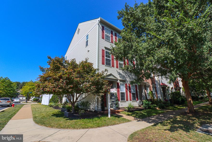 This award winning Miller & Smith 'Regents' model END UNIT townhome has a 2 car detached garage with plenty of storage. The spacious home has 2200 sq ft of living space and is sited on a tree lined street giving it that charming small town feel! Located in the heart of South Riding just a few short blocks to pools, restaurants and shopping   This unique floor plan offers convenient ground level entry into the main living level   Large formal dining room off the entry foyer would also make a great home office  with 10 foot high ceilings and flowing hardwood flooring on the main level.   Kitchen has granite counter tops, 42" cabinets and large center island with seating, and new appliances and pendant lighting.  The kitchen overlooks the great room with tons of natural sunlight and large windows.  This leads to a wonderful and private courtyard style deck with built in storage areas.  The deck is a perfect entertaining area your guests   The second level has a spacious owner's suite with walk-in closet, gas FP, built in bookcases, an en suite bathroom with double vanities, soaking tub and separate shower.  There is a separate versatile Den/4th bedroom .  The laundry room completes this level   Top level living spaces include two guest rooms, each with a walk-in closet and private vanity/sink area w/ a second bath and a relaxing retreat/family room w/entertainment niche.  The garage has build in cabinets and lots of storage.  This home is in a perfect location and is move in ready.