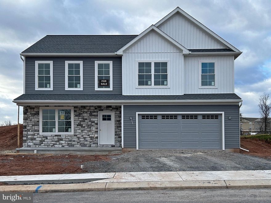 * $5,000 Builder Incentive offered on all homes! Call for details. *

NOW UNDER CONSTRUCTION! There are so many things to like about this three bedroom, two bath, raised rancher plan. Enjoy the openness of the main living area as your family and guests gather around the action. The kitchen includes a 5′ island, granite countertops and pantry cabinet. The primary bedroom features a private bath and walk-in closet. Bedrooms 2 and 3 are just steps from the hall bath and laundry. The lower level has a large, unfinished area in addition to the two car garage and a finished flex room. Who doesn’t enjoy relaxing on a front porch or the back patio? Enjoy the view as you watch the changing seasons from this hilltop location.
This home will be completed and ready for an early February settlement.