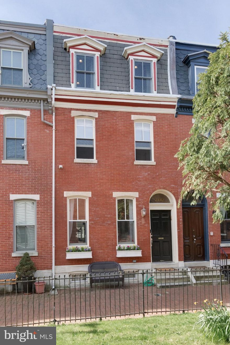 Location. History. Style. Comfort. Greenery. Parking. 2332 Saint Albans has it all and is located on one of the most desirable blocks in and around Center City, the "garden block" of Saint Albans. Featuring brick sidewalks lining both sides of a central, wrought iron fenced green space extending the entire middle of the block, you, your family, and friends will enjoy the calm and quiet of this unique setting where neighbors relax on benches and children play outdoors, free of parked cars and traffic. The exterior of the home is an original brick facade featuring marble steps, window sills, and lintels; a demi-lune transom doorway; a slate-tiled mansard roof, and a classic 6-panel wooden door. Inside you'll enter into a gorgeous, welcoming, foyer complete with mosaic tiles, a multi-light door, shoe cubbies, and coat hooks. Beyond the foyer, you will be welcomed by solid oak floors extending throughout the home, a light-filled living room featuring a Victorian marble chimneypiece, and neo-classical moldings framing the opening to the dining and kitchen areas. A powder room is tucked into the corner of the dining area. Room for dinner for 10 runs parallel to the lovely, sky-lighted staircase, beyond which is a recently remodeled kitchen featuring a new bank of south-facing windows, marble counters supported by shaker style cabinetry, ceramic tile backsplash, and a wall of cabinetry surrounding the refrigerator. The cabinetry is complimented by open shelving and a brass cup and pot rail. The kitchen offers access to the rear of the property which doubles as a gated parking space and a private patio. There is room to keep tables, chairs, bikes, and/or a scooter along with a full-size car. Parking on the street on the days you are entertaining gives you plenty of space for outdoor dining, lounging, and play. Back through the kitchen and up the stairs brings you to what was originally the 4th bedroom and is now a most welcoming office, study, or television room. Lined with floor-to-ceiling custom bookcases, a niche for a monitor, and a charming window seat tucked into the south-facing bay window, this will become one of your favorite rooms in the house. The remainder of this floor is home to the primary suite located beyond French doors and includes a large bedroom with recessed lighting, a gas fireplace, customized closets, and a large bathroom including a soaking tub, shower stall, and double vanity, all of which are surrounded by white marble and blue ceramic tile. Upstairs on the 3rd floor, you will find two spacious bedrooms. The front bedroom features two customized closets, one for clothing, and the other contains a desk and room for storage. There is also a 2nd gas fireplace. The 4th bedroom has a south-facing window for great lighting all day. The hall bath is lovely and features a free-standing, claw-foot tub with shower, a pedestal sink, and a large linen cabinet. Next to the bathroom, off the hall, is the laundry station. Back down the stairs to the basement, you will find a cozy television or playroom, an office space with a large south-facing window, and in the front, a full bedroom with a good size closet. This bedroom is currently filled with boxes in preparation for moving. There is also a full bath on this level, making the bedroom a perfect guest space. From the solid bones and historical features of a classic Philadelphia row home, to the high-quality recent renovations done with extraordinary style and taste, to the impeccable location on an amazing block in the Chester Arthur Catchment, and with walkable amenities in every direction, this is a property that you do not want to miss out on.