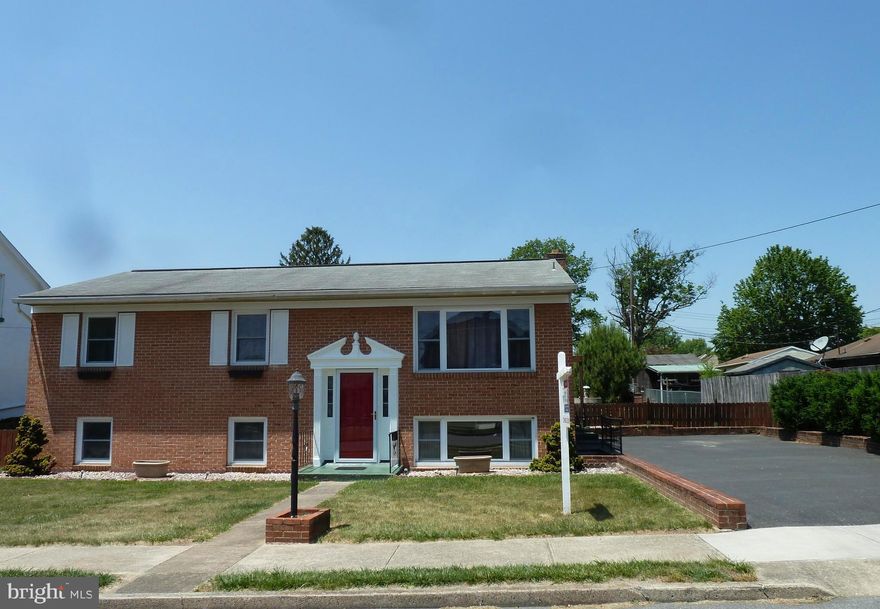 One owner, well cared for, all brick split foyer situated on a double lot with huge back yard and a detached building that's a rare find! This home boasts all the functionality needed on the main level with mostly wood flooring, a spacious living room, kitchen/dining combo that leads to the rear patio/yard, three spacious bedrooms and a full bath. The lower level offers a large family room with wood burning fireplace, another separate room with two closets and cabinetry, 1/2 bath, exceptionally large laundry room with sink and lots of storage cabinetry, and outside entrance/exit.  The detached building provides an abundant amount of possible uses since it has two adjoined areas of space - maybe create an entertainment area, work shop (one side has work bench and cabinetry), work space for the hobbyist, place for the kids to play, home office??? Make it your own! There's plenty of parking with the main driveway beside the house and rear driveway off the alley beside the building. Come see all this property has to offer before its gone! Measurements approx.