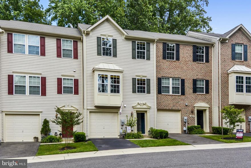 Built in 2010, privately situated on quiet dead end street offering ample parking & a lovely wooded view. Elegantly appointed with quartz countertops, luxurious cherry cabinets, beautiful hardwood floors,  custom premium wood blinds, **8ft bump-out** & Azek deck. Tennis courts, basketball, tot lots. Easy access to walking trail leading to boardwalk and waterpark. Only one mile to marina & beach.