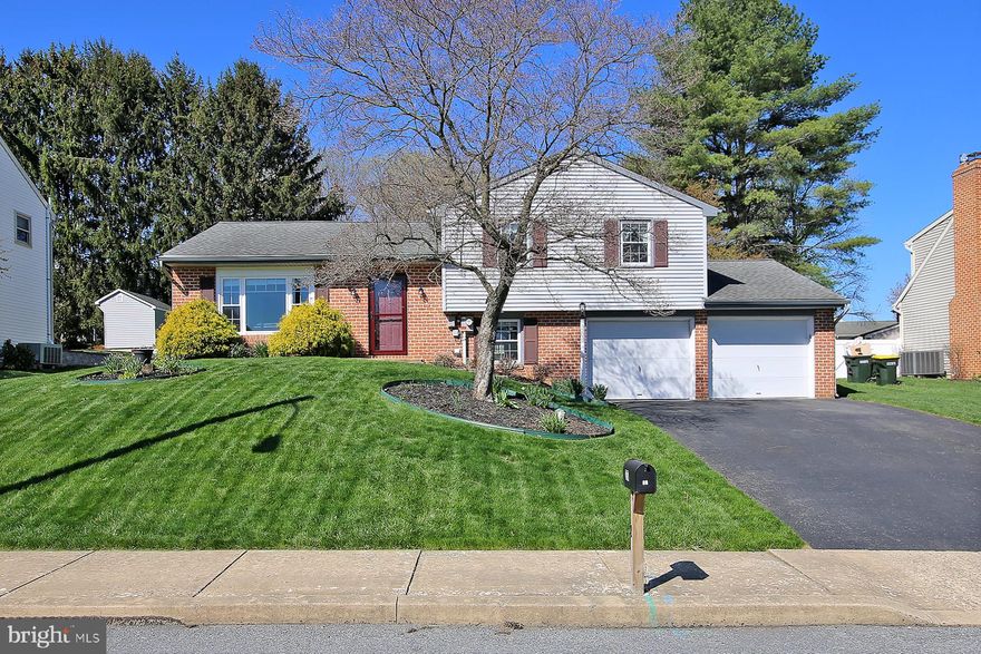 This charming split-level home offers a perfect blend of comfort and functionality. This residence features three inviting bedrooms and one and a half bathrooms. The open floor plan creates a warm atmosphere, ideal for both relaxation and entertaining. The kitchen boasts an island and built-in appliances, including a convenient electric oven and range, making meal prep a delight. Step outside to discover a lovely brick patio, perfect for morning coffee or evening gatherings. The exterior is enhanced by stone retaining walls and a play area, providing a wonderful space for outdoor activities. The attached oversized garage offers ample storage and easy access, complemented by a spacious driveway that accommodates additional vehicles. Nestled in a welcoming community, this home is surrounded by local parks and recreational areas, perfect for outdoor enthusiasts. Enjoy the convenience of nearby public services, ensuring that everything you need is just a short distance away being that it's only 3 minutes away from Green Dragon, minutes from 83, or 30. This property is not just a house; it's a place to create lasting memories.