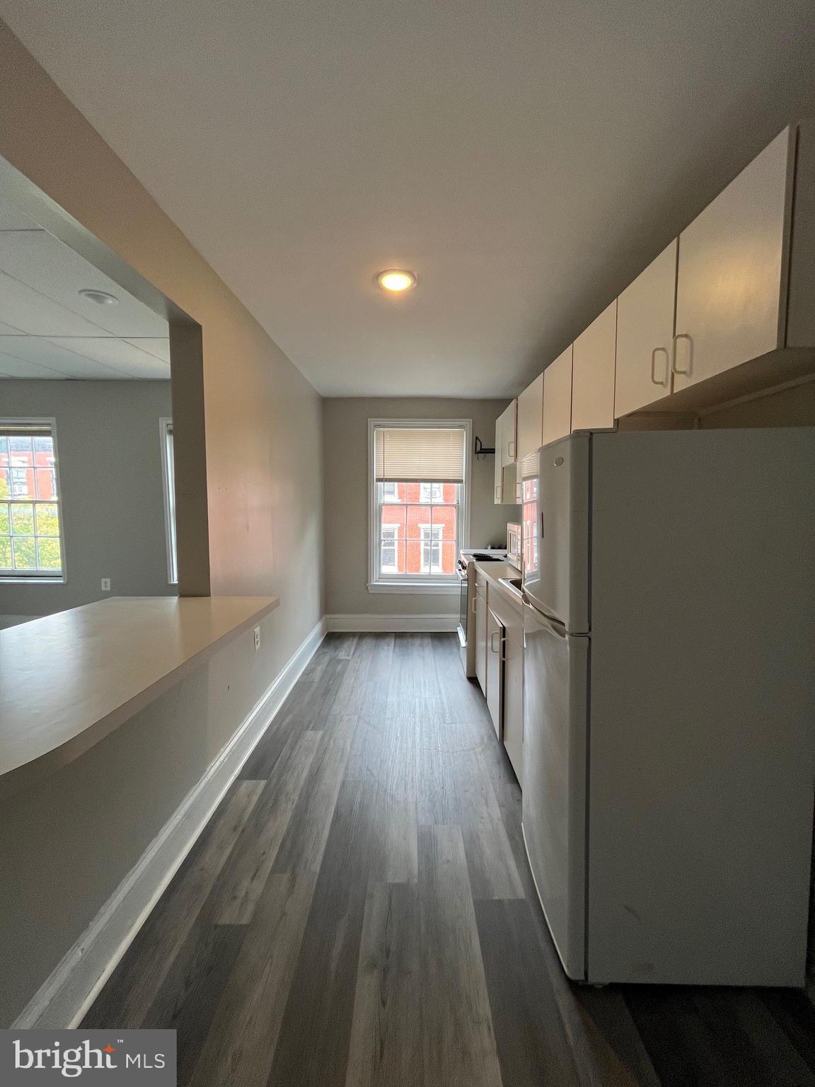 This 4th floor walk up includes new hardwood type flooring, and updated bathroom & generously sized floor plan. The full size kitchen sits off of the living room with a counter top for seating. Large windows provide a lot of natural light. The large bedroom sits off of the living room and includes a nice sized bathroom.