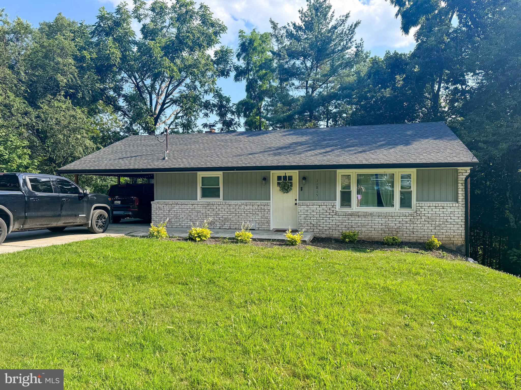 ASSUMABLE USDA 5.2% LOAN!!! MOTIVATED SELLERS - ALL OFFERS CONSIDERED, sellers are relocating for work!!! This Potomac Park 4 bedroom Rancher has over 2,000 finished square feet and is move-in ready! This home was fully renovated in 2022 including a brand new HVAC, new roof and soffit/fascia, new windows, refinished hardwood floors, and beautiful tile work and granite countertops in the kitchen and bathrooms! Each level has 2 bedrooms and 1 full bathroom with a living room and custom kitchen on the main level and a family room with wood-burning fireplace and wall of windows along with a laundry room on the lower level. With a rear-entry garage accessible via the lower level and a carport/covered patio accessible on the main level plus a driveway that can easily fit 6 cars, there is always room to park! You can access the private rear fenced yard with scenic mountain views from the lower level walkout exit or from the side yard and driveway. The main level bathroom features double sinks with a bathtub and ceramic tile while the lower level bathroom includes a large walk-in tiled shower. Enjoy the new park and two dog parks located in Potomac Park! The carport fits a patio area with seating behind a full-sized vehicle with room for another full-size vehicle in the top driveway PLUS parking for 4+ in the side driveway! This beautifully renovated house is ready for you to call home - schedule your tour today!