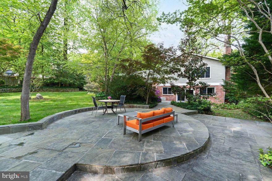 This elegant and spacious residence offers a beautifully updated interior and thoughtfully designed floor plan spanning 3,744 square feet. Tucked away on a quiet cul-de-sac in the highly sought after Sleepy Hollow area, the neighborhood is unlike most with no through streets, minimal traffic, and a tranquil setting zoned for just two dwellings per acre, providing the rare combination of privacy, tranquility, and accessibility all just minutes from the area's top amenities.  Step inside to discover an inviting living room that flows effortlessly into the formal dining area. Sliding glass doors open to an expansive slate patio, creating a seamless indoor-outdoor living experience. The gourmet kitchen is equipped with 42-inch maple cabinetry, gas cooking, a pantry, and an overhang, allowing for bar seating. A charming breakfast nook with bay windows and additional storage offers the perfect spot for casual dining. Throughout the home, you’ll find gleaming hardwood floors, high-end energy-efficient windows, and well designed spaces ideal for relaxation, work, or entertaining. The large two-car garage includes a dedicated workshop and ample storage.  The luxurious primary suite is a serene retreat, featuring two custom walk-in closets, oversized windows that fill the room with natural light, and tranquil views of the lush backyard. The en-suite bathroom offers a Jacuzzi tub, dual vanities, and a separate standing shower. Two additional bedrooms share a well-appointed full bath and complete the upper level.  The lower level expands the living space with a versatile family room centered around a fireplace, a spacious laundry room, steam bath, a fourth bedroom, and a full bathroom. An additional (4th) level provides a spacious, luxuriously carpeted multi-purpose recreational area with wet bar and generous additional storage and serves as a haven in the warmer months, and a cozy TV nook. The professionally designed hardscape and multiple outdoor patios extend the home’s impressive living space, making the backyard an integral part of its charm.  Ideally located near shopping centers, restaurants, and supermarkets—and just 10 minutes from the Mosaic District—this home also provides excellent commuter access. The nearby Seven Corners Transit Center connects you directly to East Falls Church, Ballston, Vienna, Tysons, and the entire Metro system.