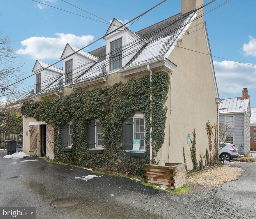 This is an exceptional opportunity to own a truly unique home and a rare piece of history. This beautifully renovated 19th-century carriage house offers 3 bedrooms and 2 full baths, blending historic character with modern convenience.  The main level features an open floor plan ideal for entertaining and everyday living, complemented by a beautifully remodeled kitchen and updated bath. Upstairs, you’ll find three bedrooms, a full bath, and a versatile multi-use family room. Several skylights flood the upper level with abundant natural light, creating a bright and inviting atmosphere throughout.  Perfectly tucked away on a quiet side street, you are just three blocks from the vibrant shops and restaurants of King Street and only a few blocks in the opposite direction from the King Street Metro.  Currently zoned CL (Commercial Low), this property offers outstanding flexibility and investment potential. The City of Alexandria’s CL zone is designed for low-intensity commercial, office, and service uses while serving as a transition to residential areas. Permitted uses include single-unit, two-unit, and multi-unit dwellings, townhouses, as well as small-scale office or personal service businesses. With two separate front entrances already in place, the home lends itself to creative possibilities — whether continuing as a single-family residence, converting to multiple units, or incorporating an approved business use.  A rare offering that combines historic charm, prime location, and exceptional versatility.  Assumable VA loan. Loan balance approximately $657,000. Interest rate 3.375%. The seller is willing to allow a qualified veteran to assume the existing loan in order to have the VA entitlement reinstated.