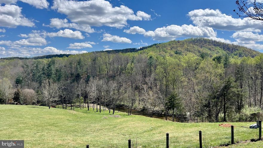 A MAGICAL PROPERTY with total privacy.  This rare find offers Mountain Views in two directions, 1/2 mile frontage on a bend in the Thornton River with swimming holes, a "beach" and even a small island.   Two ponds are stocked with fish, a vernal pool hosts peeping frogs & salamanders, two large fenced pastures or hay fields, livestock corral and chute and several shady bottoms along the river teeming with fish, ducks, herons and patrolling eagles.  ** THE BUILDING SITE is spectacularly set on a wide elevated ridge at the center of the land, with 1/4 mile driveway, buried power, 7gpm well and 3 bedroom septic already installed.  Nicely graded and ready for new construction.  A one room timber frame  cabin with Anderson windows and an outdoor shower sits above the river for your enjoyment with a 40' deck overlooking the bottom land of dappled shade and  river.  In all, a Naturalist's Paradise with trails, quiet places, magnificent rock formations, swimming spots, wildlife and a fine 4 bay closed shed with concrete floor for machinery, shop, garage, what have you.   Conservation Easement guarantees favorable Land Use taxation and provides for building your new home and ancillary structures.