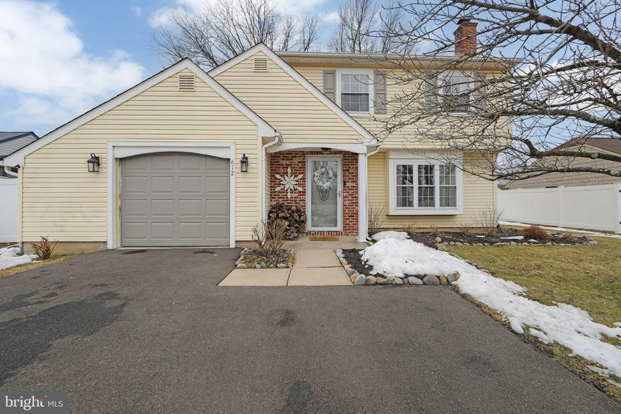 Pride of ownership shines throughout this charming Colonial-style home in Fairless Hills. The expanded driveway offers ample parking, along with a one-car attached garage featuring convenient interior access. A covered front patio welcomes you into the formal living room, highlighted by a beautiful bay window and cozy fireplace. Luxury vinyl plank flooring flows throughout the entire first floor. The tastefully updated kitchen features new cabinetry, countertops, and stainless steel appliances, and opens to a spacious dining area—ideal for hosting meals and making lasting memories. The dining space flows seamlessly into the rear family room with vaulted ceilings and access to a large back deck overlooking the fully fenced yard with brand-new vinyl privacy fencing. This outdoor space is perfect for entertaining, relaxing, and play. Completing the first floor is a convenient powder room and a laundry/utility room with a new hot water heater. Upstairs, the primary bedroom offers a walk-in closet and private access to the beautifully remodeled hall bathroom, complete with a luxurious deep soaker bathtub. Two additional comfortable bedrooms complete the second floor, with newer carpeting throughout. Additional highlights include a central air conditioning system just three years young, complete with an extended warranty that includes regular maintenance. This move-in ready dream home is ready for its new owners—welcome home!