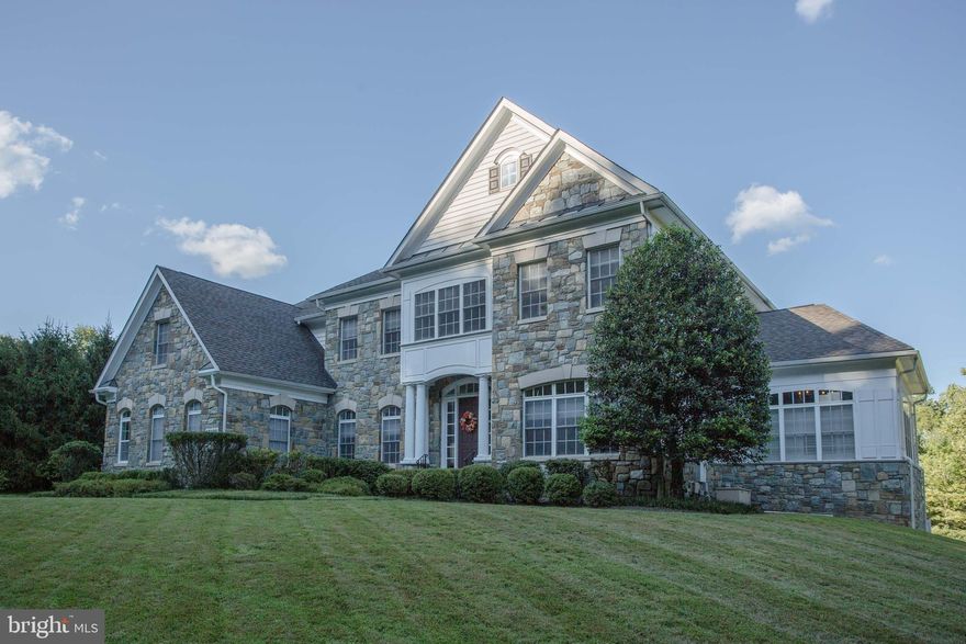 Welcome to 17409 Ashton Green Drive! Built by award winning builder, Mitchell & Best, this stunning home sits in the highly sought-after Bancroft community. Nestled on a little over a half-acre of land, the home presents 5 bedrooms, 4.5 bathrooms, and 6,950 finished square feet. Gorgeous stonework on the front provides the ultimate curb appeal and truly makes a statement in the neighborhood. Stepping inside you will immediately appreciate the grand 2 story foyer with custom wainscoting on the walls that flow directly into the dining room on the left. To the right of the foyer is a light filled sitting room which is nicely accented with architectural columns. The rest of the main floor shows a kitchen, breakfast nook, laundry room, half bathroom, access to the 3-car garage, living room, office, and a sunroom. The living room is elegantly designed with its coffered ceiling, stone fireplace, and custom built in shelving. Behind the living room sits the kitchen which features an oversized island, granite countertops, and tons of cabinet/countertop space. This kitchen can handle even the largest family gatherings! Walking out of the breakfast nook door, a large composite deck awaits. The deck overlooks a private backyard space and walks down to a custom oversized paver patio. The paver patio continues to a paver walkway and wraps around to the front of the home. Stepping back inside and up to the second floor you will be greeted by 4 bedrooms and 3 full bathrooms. The primary bedroom is absolutely awe inspiring with tall ceilings and large windows throughout. The main bedroom space flows directly into a natural light filled sitting room. In-between the two spaces resides a dual sided gas fireplace. The room also shows dual walk-in closets and a luxurious spa like bathroom. Heading down to the lower level you will be greeted by brand new carpets, a bedroom, a full bathroom, and a walk out to the rear patio. This space features full length windows throughout and is ready for your personal touches! The home is surrounded by beautiful landscaping which is maintained by the HOA and features its own tesla vehicle charger. This home is in a prime location as it is just minutes away from the Olney Village Center, multiple golf courses, MD-200, MD-97, and MD-108. Schedule your showing today!