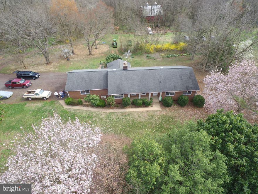 Farm living close to town.  41.2 acre farm with custom built all brick rambler.  First floor has 3 bedrooms with two  full and one half baths.  Master has en-suite bath  Kitchen has a unique indoor gas grill.  Basement is fully finished with three bedrooms and 1 full bath, as well as a kitchen, large storage closet and mechanical closet.  Garage is an oversized two car with a separate workshop area in the garage.  Both levels have laundry.  Fireplaces on each level.  This is a solidly built home, stick built in 1970.  It does need some  updating, but is in excellent shape and has been well cared for.  Barn is solid and can be turned into a stable if desired.  Full time stream traverses the property.  Mountain and panoramic views abound.  Owner financing available.Square footage assessment is incorrect.   The total finished square footage (including finished basement) is 3,891 square feet.  Farm is currently in land use.  OWNER FINANCING AVAILABLEalso listed as farm under VACU 141504