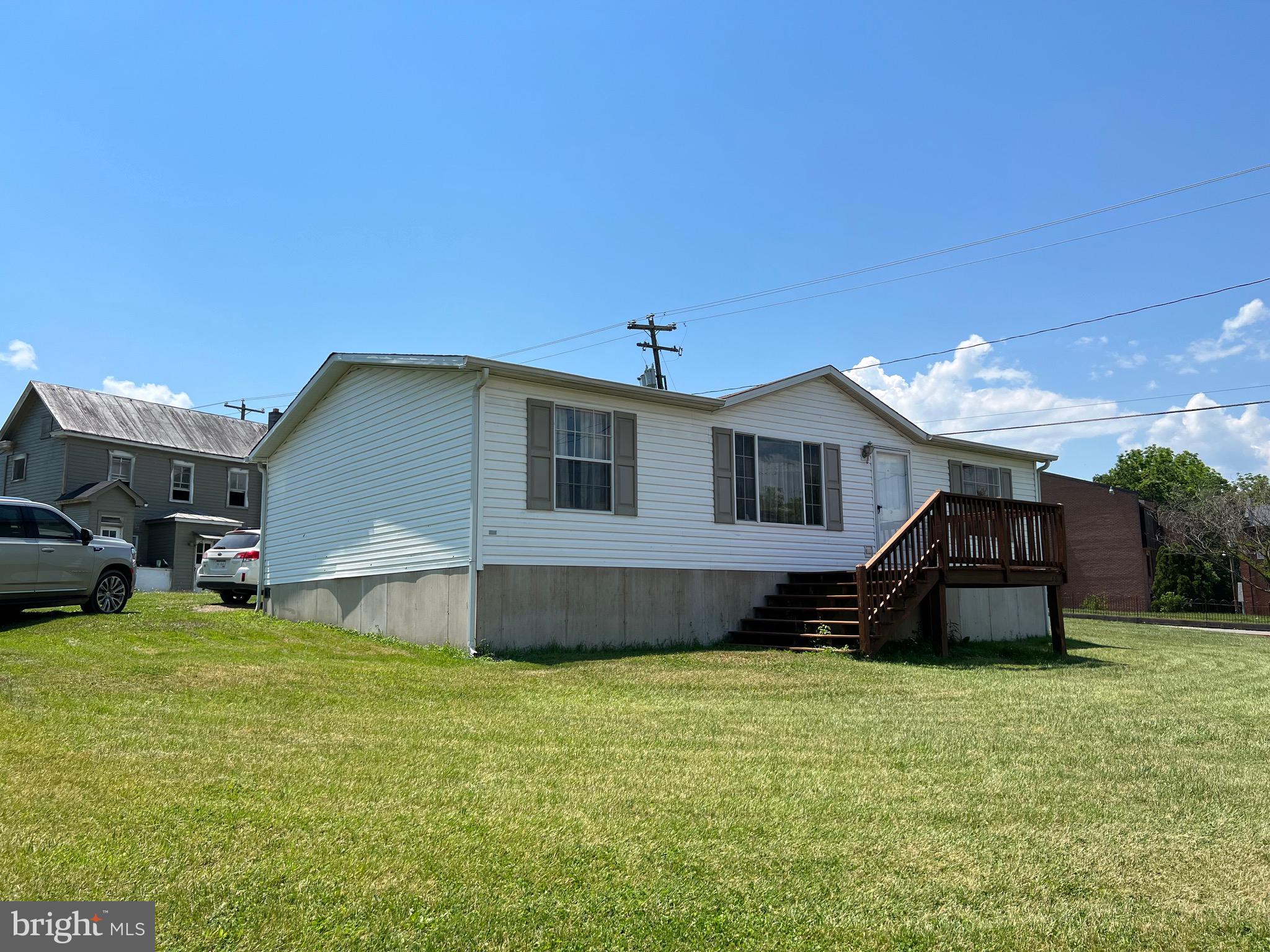 Price Reduced! Ready to Move In! This 2006 double wide features: 3 bedrooms (primary BR has attached bath and walk in closet), 2 baths, eat in kitchen with range & refrigerator plus hookup for washer/dryer, living room. Freshly painted interior, new carpet in bedrooms, hardy plank flooring in LR, new roof in 2016. Situated on .20 acre lot in Paw Paw. Public water & sewer, electric forced hot air heat.