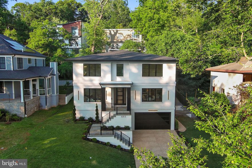 A Rare Opportunity—Exceptional Value in Sought-After Glen Echo

Now priced to impress, 6815 Barr Road offers discerning buyers a fresh opportunity to own a truly remarkable new-construction home in the coveted Whitman/Pyle/Bannockburn school district—just minutes from DC, Northern Virginia, and downtown Bethesda.

This elevator-equipped residence spans over 6,200 square feet of high-end living, thoughtfully designed for comfort, style, and flexibility. Enter into a dramatic foyer flanked by formal living and dining rooms, where hardwood floors, coffered ceilings, and abundant natural light set the tone. A sleek butler’s pantry with dual beverage refrigerators connects seamlessly to the gourmet kitchen, featuring a striking waterfall island, six-burner gas range, paneled appliances, and designer finishes.

The open-concept family room—with a bold gas fireplace and fluted surround—invites connection and flow, extending effortlessly to the back patio for easy entertaining and everyday indoor-outdoor living.

Upstairs, the spacious primary suite offers a private retreat, with tray ceilings, custom walk-in closets, and a spa-worthy bath with soaking tub and zero-entry shower. Three additional bedrooms each offer en-suite baths and generous space. A beautifully appointed laundry room completes the upper level.

The finished lower level delivers on flexibility and function, with a sprawling rec room, full wet bar, and a private fifth bedroom suite ideal for guests, teens, or live-in help. A two-car garage with modern glass doors adds curb appeal and everyday convenience.

This is not just a home—it’s a value opportunity in one of the area’s most desirable locations. With unbeatable access, premium finishes, and room to grow, 6815 Barr Road is ready for its next chapter. Don’t miss your chance to make it yours.