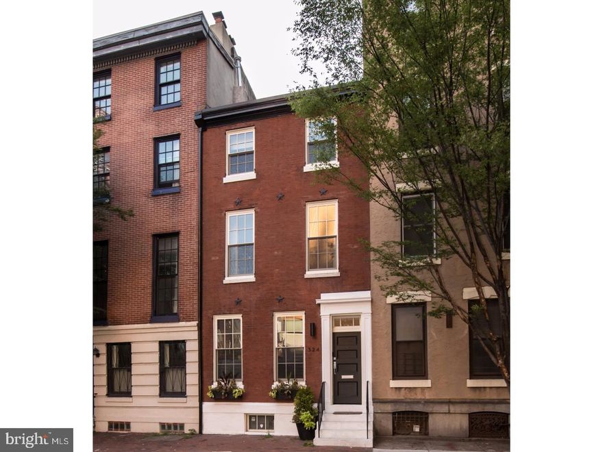 Here is your chance to live in a stunning renovation of a classic Philadelphia Brownstone, just completed in 2017 and encompassing over 3,000 sq ft of updated, modern living space. Behind the handsome brick fa ade, you will find a modern 4 bedroom + den/3.5 bathroom home. Enter through a custom tile vestibule into an open living room with a beautiful fireplace, and the first of many extraordinary modern crystal chandeliers. Ebony hardwood floors, that continue throughout the home flow into the open kitchen, which is the heart of the first floor. Features include an oversized island with white quartz waterfall sides, a high-end Viking appliance package including range hood, ample wood cabinetry, and endless natural light streaming through an oversized window. The backsplash is one piece of seamless Carrara marble. The separate dining room benefits from multiple exposures of light, overlooking the private patio.  The first floor is rounded out with a convenient powder room and a practical coat closet. A custom oak staircase with metal handrails leads you to the second floor where you will find 3 spacious bedrooms and two full bathrooms clad in marble and high-end Koehler and Moen Fixtures; one of the bedrooms has an attached bath perfect for an au pair suite. On the third floor, an open den/lounge leads you to the master suite of your dreams! The spacious bedroom has a sizeable walk in closet that has been customized by California closets to provide an abundance storage, with adjoining washer/dryer on the bedroom level. The master bathroom features a freestanding soaking tub, oversized frameless glass shower and a dual vanity with Carrara Marble counter. The spacious finished basement has finished concrete floors and a large closet providing even more storage. 3 zoned HVAC with nest thermostats, a security system, and an EPDM commercial grade roof are just some of the features that will keep you comfortable in this home. Seller to include 2 years of pre-paid parking at nearby lot with an acceptable offer!