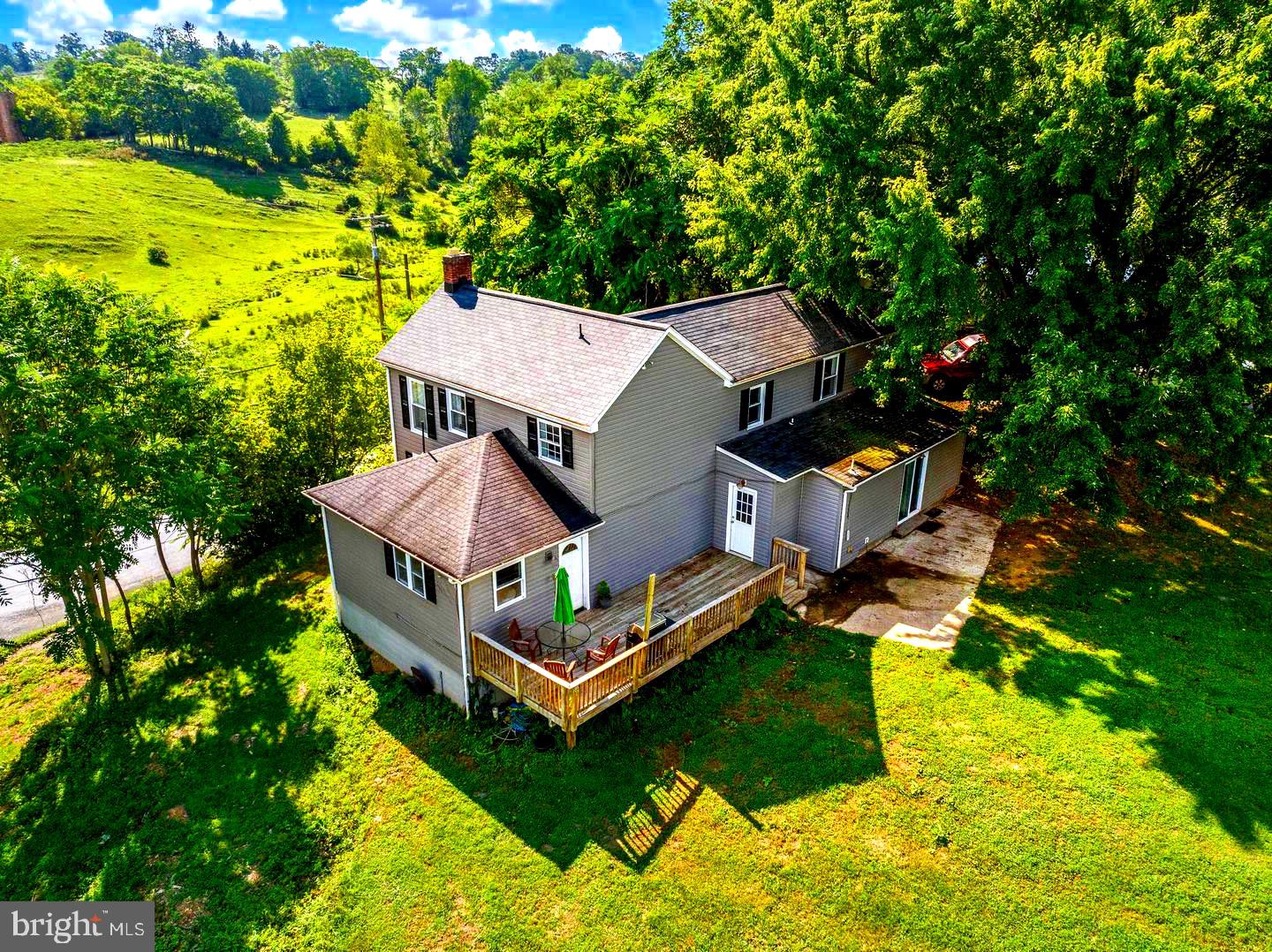 Fantastic opportunity! This desirable property is now offered at a new, incredible price!! Let’s talk about space and privacy!!! This beautiful home features brand new paint and flooring. GORGEOUS kitchen and modern baths set on 2.24 acres on the border of 100 acres of preserved land that will never be developed. Brand new sidewalk and landscaping! Perfect spot to homestead, have animals or farmette!! Got ATVs? Need RV parking? You are covered here for riding, camping, and everything in between! Inside, you'll find an open floor plan featuring a stunning kitchen with white cabinets and quartz countertops paired with stainless steel appliances. The open floor plan incorporates a dining room and living room complete with a wood-burning fireplace. The first floor also offers a mud room, an updated powder room and first floor owner's suite. The owner's suite includes an ensuite bath with a large walk-in closet leading directly to the patio, perfect for coffee in the morning. Upstairs you'll find three large bedrooms and a full bath. Outside is flanked on either side by a custom deck and large front porch. The detached two car garage features a wood stove, washer/dryer and refrigerator, perfect for in home dog boarding, grooming, home gym, art studio, or gardening shed. The shed row barn is open inside and can easily work for sheep, pigs, goats, or storage of equipment. The home offers incredible privacy and seclusion.