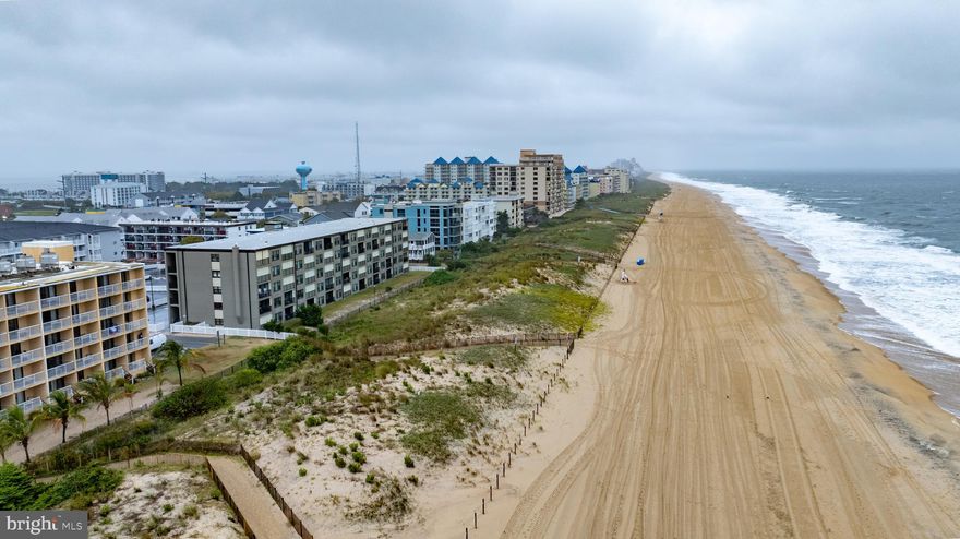 Welcome to Ocean Trail Condominiums, perfectly located in the heart of Midtown Ocean City. This completely furnished spacious  2BR, 2BA  first-floor condo combines comfort, convenience, and coastal charm--all just steps from the Beach.
Inside, you’ll discover a spacious primary open-concept living and dining area that flows seamlessly to a private balcony, ideal for enjoying your morning coffee and listening to the soothing sounds of the Ocean.
 The updated Kitchen features new stainless steel appliances, granite countertops, stylish cabinetry, and an all-in-one washer/dryer combo.  The large primary suite boasts its own private bath, while the second bedroom offers plenty of room for family and guest.
Additional highlights include elevator access, 2 assigned parking spaces, faux wood blinds and an outdoor shower for rinsing off after a day in the sand. 
With a prime midtown location near the Ocean City Convention Center, Seacrets, top restaurants, shopping and entertainment , this condo is perfectly suited as a full-time residence, vacation retreat or lucrative rental investment. Come and experience the ideal blend of relaxation, convenience and coastal living at Ocean Trail Condominiums.
