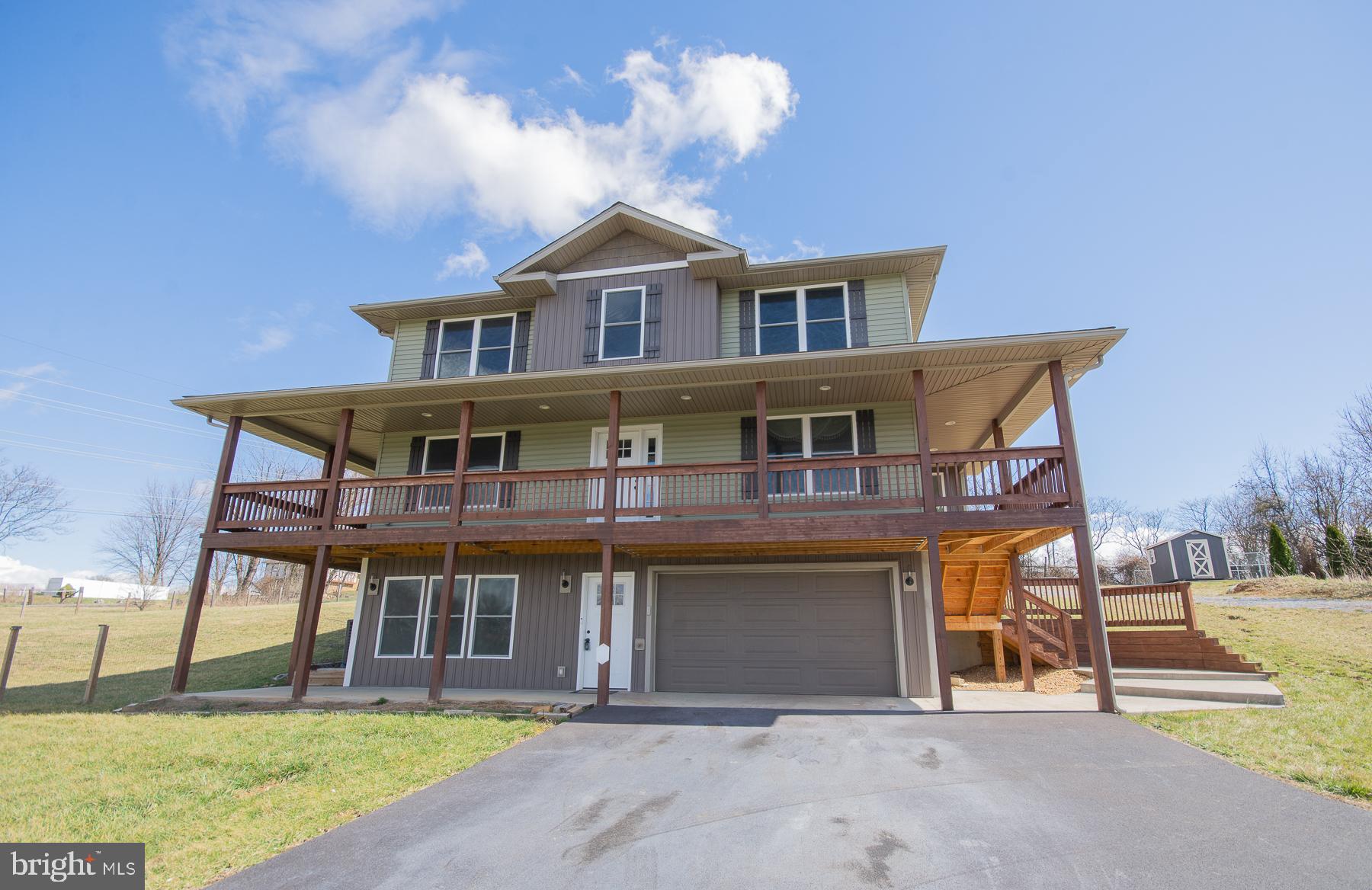 Looking for a home that offers a mid level wrap around porch that will offer you scenic views. Enjoy the privacy of country living only minutes to shopping, medical facilities, restaurants, etc. You will enter the lower level that offers a family room, full bath, and entrance from your 2 car garage. Once going up to the mid level you will have your main living space, kitchen with granite countertops, unique backsplash, stainless appliances, open to your breakfast area, living room, dining room, and a main level bedroom. On this level you will have access to your lovely wrap around deck. Upper level offers 3 more bedrooms, that includes the Primary bedroom suite with setting area, walk in closet, tray ceiling, double sink with granite countertops, separate shower, and garden tub. The rear fenced in backyard has a small kennel area and outside building. You need to see this home to appreciate the beauty it offers inside and out. Please call today to view this home and for all your real estate needs.