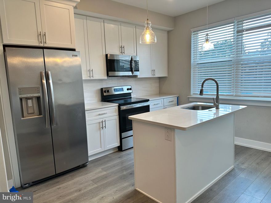 The moment you step into this top floor bi-level unit, you'll be greeted by the generous influx of natural light streaming through the expansive windows, creating an inviting and uplifting atmosphere. The modern kitchen effortlessly balances sleek elegance with practical functionality. Embrace the convenience of keyless entry, which grants access with ease while enhancing security. Your peace of mind is further supported by the comprehensive security features thoughtfully integrated throughout the property. On the first floor, a discreet powder room adds convenience to daily living. Journeying to the second floor, you'll discover two tranquil bedrooms, each offering a private retreat. The well-designed full bathroom on this level caters to your personal care needs. Step outside onto your private roof deck, where you can savor moments of relaxation and fresh air in an exclusive setting. $75 monthly water fee will cover all cold water usage. First, last and security deposit required to move in.  Located near major highways, public transportation and local entertainment such as The Ground Coffee, Sor Ynez and Four Humours this unit and all its amenities are sure to not disappoint!