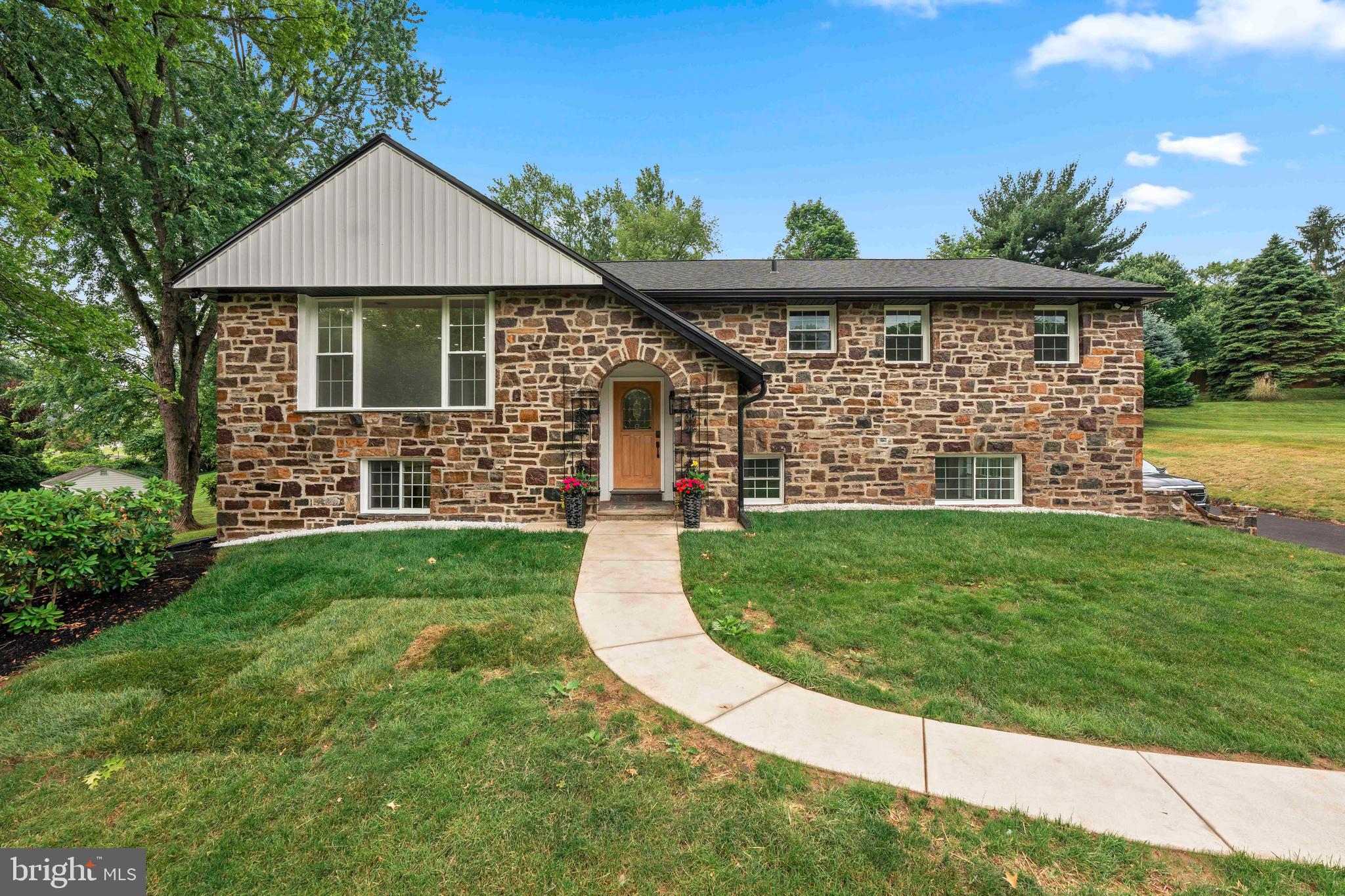 Prepare to be swept away by this extraordinary fully renovated residence in one of Huntingdon Valley’s most desirable neighborhoods and Lower Moreland school district. Every inch of this five bedroom five and a half bath home has been reimagined with uncompromising quality, cutting edge design, and sophisticated style, offering a rare blend of upscale living and everyday comfort.
From the moment you arrive, the striking stone facade makes a bold first impression, hinting at the thoughtful craftsmanship found within. Step inside to an expansive sun filled interior where rich hardwood floors stretch across the main level, setting the stage for a seamless open concept layout. Designed for effortless entertaining and relaxed living, the airy floor plan flows into an awe inspiring chef’s kitchen, the true heart of the home. Here, a dramatic waterfall edge island, crisp white Café appliances, and sleek quartz countertops are complemented by oversized sliding doors that open to a sprawling composite deck overlooking your private backyard retreat.
Imagine sipping coffee on the deck as you gaze out over the beautifully landscaped yard, transformed with more than $20,000 in tree work and professional upgrades. The heated saltwater pool and expanded concrete surround create the ultimate setting for summer relaxation and entertaining. A newly installed vinyl fence enhances privacy and adds a clean modern touch to the outdoor space.
Back inside, the main floor features four generously sized bedrooms, each with its own stylish en suite bath, an ideal layout for comfort and convenience. The luxurious primary suite is nothing short of a dream, featuring a new custom designed walk in closet and a spa inspired bathroom. Enjoy a deep soaking tub, glass enclosed shower, and a double vanity with elegant finishes, all designed to provide a tranquil retreat.
The finished lower level offers even more flexible living space with a warm and welcoming den centered around a gas fireplace that has been recently converted and enhanced with a beautifully refurbished stone hearth. This level also includes a full bedroom, a bathroom, a dedicated office space, and a stunning new dry bar complete with custom countertops. Sliding doors lead directly to the backyard, creating a smooth transition between indoor and outdoor living.
Recent significant improvements have been made throughout the home including a new roof, gutters, windows, siding, HVAC system, and composite deck. The attic has been fully insulated for greater energy efficiency, and a custom closet was recently added to the primary suite for enhanced storage and organization.
With over 5000 square feet of beautifully finished space, this exceptional home offers a unique combination of style, function, and move in ready luxury. Whether you are hosting guests or enjoying quiet moments with family, this home delivers on every level.