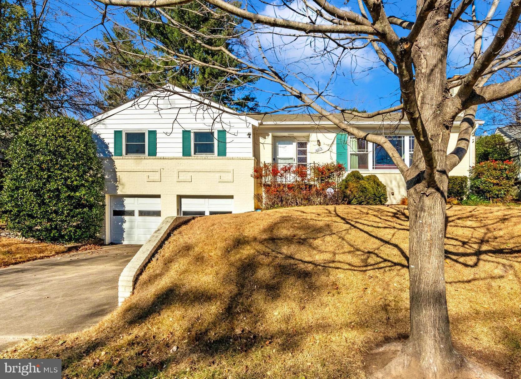 Offer deadline Saturday 12/14, end of day. Seller will review on Sunday 12/15. Exceptional Location! Quiet residential enclave with exceptional privacy nestled in a vibrant, urban area. Walk to parks, metro, restaurants and shopping! Lovingly maintained raised rancher showcases original hardwood flooring, crown molding and wide baseboard. Living room features a central picture window and two additional double hung windows providing outstanding natural light. Built-in shelving with base cabinets flank fireplace with natural gas insert. Formal dining room with built-in china cabinets and side board opens to kitchen and sun room. Updated kitchen features Watkins cabinets, SS appliances, center island, Quartzite countertops and tiled backsplash. Beautiful sun room opens to patio and yard. Main level primary bedroom with dual closets and en-suite bathroom. Two additional bedrooms and second full bathroom on main level. Partially finished lower level with laundry, half bathroom, utility room, rec room, two large storage closest and walk-out stairs to rear yard. Paved driveway and attached, oversize 2-car garage provides ample, off-street parking. Perfect floor plan and outdoor space for entertaining! Soaring trees and mature landscaping provide privacy. Updated roof (2011), hot water heater (2023), HVAC (2022).