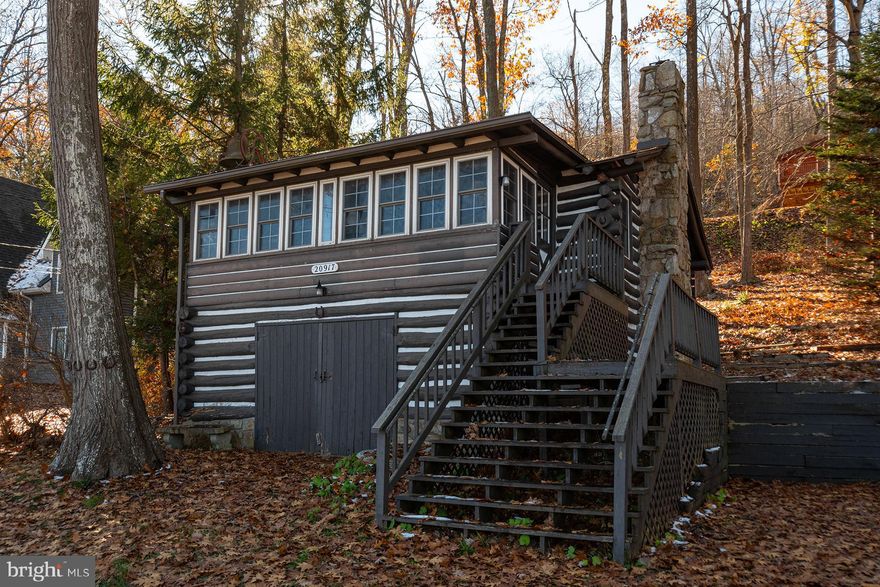 Welcome to 20917 Garrett Highway, an enchanting retreat nestled on the shores of Deep Creek Lake!  This timeless log cabin, buit in 1940, exudes the charm and mystique of an original Deep Creek Lake gem.  Boasting split lakefront access, this cabin offers an exclusive 100 feet of private lakefront with a dock slip to take full advantage of spending sun filled summer days on the lake!  Revel in the breathtaking views that strecth across one of the lakes widest points extending into Cherry Creek Cove.  This home is not just a dwelling, it's a narrative of Deep Creek Lake's rich history and an invitation to create memories of your own!  Don't miss this potentially once in a lifetime opportunity to own a piece of Deep Creek Lake's legacy.  Schedule your tour of this iconic lakeside retreat today!