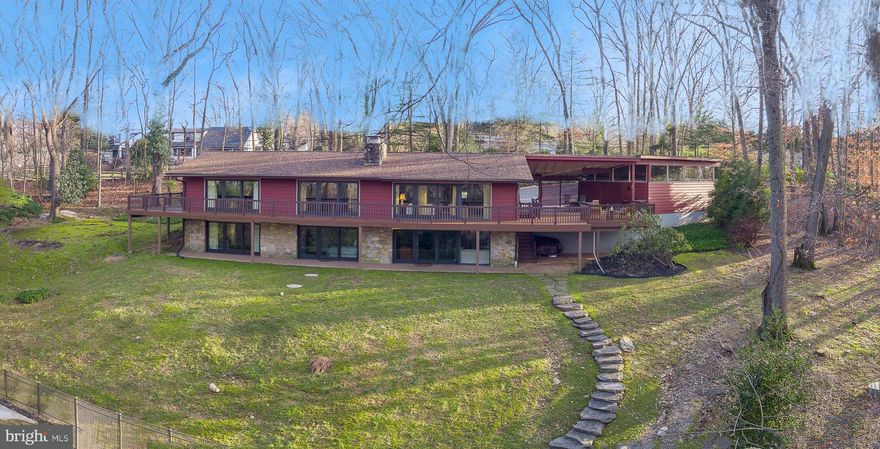 A rare find in Tredyffrin Township, this custom contemporary home is situated in a beautiful, private and quiet setting with an expansive pool and scenic views.  Updated with a careful eye to architectural details and design features, this home offers modern living at its finest!  
Welcome to 709 N Valley Forge Rd in Devon, located in the highly desirable neighborhood of the Shand Tract, a community known for its active neighborhood association and family-friendly events. This home offers a total of 3,480 sq. ft. of living space, situated on 2.5 acres of land with fabulous views, a true oasis.
Step inside the welcoming Foyer to an elegant living space flooded with natural light, providing an airy and inviting atmosphere. Beautiful hardwood flooring, high ceilings and front-to-back views tastefully set the stage for the remainder of the home. The Living Room features a stunning floor to ceiling stone fireplace shared by the Dining Room as a side backdrop wall. The Living/Dining Area also features glass sliders that open to a ¾ wraparound composite deck offering spectacular views from everywhere in the house and providing you with access to the outdoors at any given time.  The vaulted ceilings of the main Living/Dining Area and Kitchen join the rooms creating a special ambiance for everyday living and entertaining enhancing the sense of openness throughout the home. The Kitchen offers functionality and flair with attractive cabinets, granite countertops, subway tile backsplash, stainless steel appliances and a large center island with storage which is a perfect place to prepare food or serve a quick meal. There is also a separate wet bar area with wine/glass racks, modern glass backsplash, & wine refrigerator just steps away from the covered outdoor patio and adjoining deck, a perfect space for hosting social gatherings and enjoying indoor/outdoor entertaining. There’s a convenient Powder Room just off the Kitchen as well.  The Oversized 2-Car Garage is accessed via the covered Patio for easy covered access from the garage to the home.
On the opposite end of the house is the Primary Suite with gorgeous hardwood flooring, high ceilings, two sets of sliders to the wrap-around deck, a large walk-in closet with storage and a stunning modern en-suite Bathroom. There is an additional main floor Bedroom with a skylight and floor to ceiling windows that has a beautifully updated en-suite Bathroom which can also serve as a Hall Bathroom.  
A sweeping open staircase leads you to the lower level, where you will find an amazing Great Room with full wet Bar, space for four bar chairs, stone fireplace, a wall of glass sliders providing ample natural light and access to the expansive backyard with an inground pool and beautiful views.  The Great Room is an excellent space for hanging out, entertaining family & friends, enjoying pool parties, or just curling up with a good book next to the fireplace. Down the hall from the Great Room, you’ll find two additional spacious Bedrooms with sliders to the outdoors and large closets, a Full Hall Bathroom, and an unfinished Laundry/Storage/Utility Room with built-in shelving.
The outdoor spaces are equally impressive, featuring a partially covered Patio area, offering an ideal setting for al fresco dining. An inviting ¾ wraparound composite Deck to enjoy all the seasons have to offer. A beautifully landscaped backyard provides a serene retreat with the in-ground pool, creating a wonderful setting for outdoor living and entertaining. Immerse yourself in the perfect blend of tranquility, comfort, and convenience, creating a welcoming haven to call home. A spacious 2-Car Garage provides secure parking, complemented by additional driveway parking for guests.
An amazing chance to enjoy the best of both worlds - a serene private setting in a superb neighborhood within the acclaimed Tredyffrin-Easttown School District. Conveniently close to shopping, restaurants, highways, train & more.