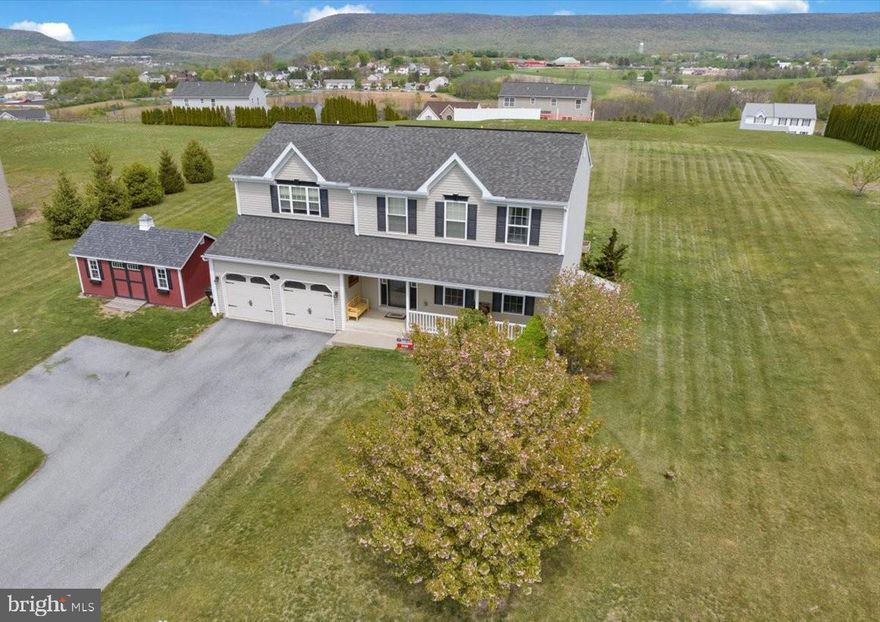 With striking panoramic views of the nearby Blue Mountains, ONE ACRE, over 2400 sq. feet of living space and with the potential to finish an additional 500 sq. ft., this well-maintained home is beautiful AND move-in ready! The proud new owners will have plenty of time to enjoy the summer in the huge backyard and still be prepared for the school year.   Located in the quiet Windsor Knoll development, a popular but rarely available community,  this ideal location allows for quick access to both local roads and major commuting arteries and is just a few minutes from the Hamburg Logistics & Commerce Park.  Outdoor adventures are also close - some literally right outside the door and others just a short drive into the mountains!  The large front lawn and porch provide a great spot for enjoying your morning coffee in the warmer months, waiting for the school bus, and for autumn, Halloween, and Christmas decorations.  The oversized driveway allows space for at least 2 parked cars out of the way of the garage doors.  Upon entering the home, the powder room and hall closet in the entry way provide convenience while a sitting room just off this area is an opportunity for a quiet home office, a playroom, or simply for more living space.  This area could even be modified to a more private area, if needed.  The sun-filled kitchen offers an abundance of storage space, along with an island and breakfast bar.  If desired, there's even room for a table, though with the dining room just off the kitchen, you might instead relish the open space.  The feeling of openness continues with the connected family room which is perfect for relaxing while dinner cooks or for nestling with a good book by the fireplace when the weather keeps you inside.  New carpeting was installed here in February of 2026!  Upstairs, the oversized primary suite is a place of luxury, comfort, and convenience.  The nook off the main part of the room is an excellent place for a vanity/dressing area, a reading or work space, or even a mini-nursery for a newborn.  The large primary en suite has a shower, a jet bath, a double sink, and a large linen closet.  
An upstairs hallway laundry area and closet add to the ease of living by eliminating all the steps usually associated with lower level or main floor laundries.   A hall bath and 3 generously sized bedrooms complete this floor.  The unfinished lower level gives the next proud owner the opportunity to easily develop an area to suit their needs - a large additional family room to host future Super Bowl or March Madness parties, space for spillover from crowded holiday gatherings or even a gaming or hobby area, all with space to spare for storage - or to use it as the current owners do, for a convenient gym and storage area that helps minimizes clutter in the upstairs living spaces!  The acre lot is the perfect invitation to spend more time outdoors.  The current owners had intended to add an enclosed patio/sunroom area and the hardscaping was prepped with footers in anticipation of this project.  The surrounding lush mountain vista provides stunning year-round views to be savored while socializing, gardening, playing with kids or dogs,  or simply relaxing.  The home also has a newer well pump and tank.  Outdoor enthusiasts will find that numerous possibilities await just a very short distance away - The Appalachian Trail, Hawk Mountain Sanctuary, state game lands, and even the Pocono Mountains, while still allowing for uncomplicated access to Newark Airport and cities such as Allentown, Bethlehem, Easton, Reading, and New York.