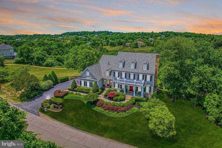 Picturesque with traditional distinction and historic personality, this exceptional Beacon Hill escape delights as silver-hued shingles and accents of stone punctuate lushly landscaped grounds surrounded by community greenspace and breathtaking foothill views. While your three car garage shelters favorite vehicles, golf clubs, and weekend projects, inside, you’ll greet guests within a double-story foyer as 8,345 square feet of hardwood floors, soothing-hues, eye-catching trim, custom built-ins, and five winter- warming fireplaces welcome. Lose yourself in a read or research online in the handsome paneled study, escape to the sunroom for creativity and a day-in from the rain, and challenge neighbors to rounds of pool where a bright and cheerful lower level keeps a cellar of your favorite local wines. While your kitchen inspires luncheon plans and holiday celebrations in your bespoke gourmet kitchen of sophisticated cabinetry, updated high-end appliances, and centerpiece island, outside, sunsets enchant al fresco gatherings under the shade of your retractable awning. Here, overlook play throughout the privacy-lending open common area, catch glimpses of wildlife during morning coffee, and make plans for adventure within Hunt and Wine Country. Five oversized bedrooms - four with en suite baths - care for dreaming. In the primary retreat, linger before dinner dates, and prep with the help of dual dressing closets, luxurious bathroom with jaccuzi tub, and thoughtful wet bar. While on tour, ask about amenities including mood-setting lightscaping,  sound system, and large list of updates, including new roof, updated paint, carpet and light fixtures.  From home, your executive-lifestyle is enviable with neighboring sprawling estates and equestrian trails. Nearby, routes lead to commuter and entertainment destinations, while area golf courses, parks, and the annual festivals, shops, and eateries of Historic Leesburg await.