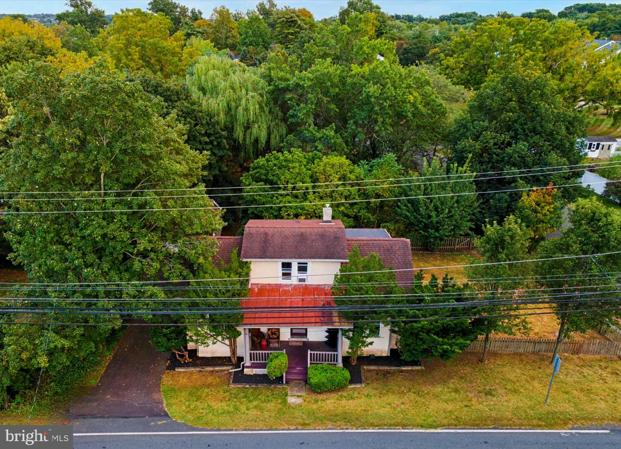 Tucked away on a serene, tree-lined backyard backing up to a picturesque public park and duck pond, this one-of-a-kind stone cottage offers a rare glimpse into Harleysville history. This home was originally built as a trolley stop in the early days of the town, and the home still showcases its solid stone construction, deep-set windows, and naturally cool interiors—a testament to timeless craftsmanship.
Step inside the first floor where exposed stone walls add rustic character to the kitchen and the unique powder room. The main floor also includes a living room, dining room area or 2nd living space and 2 secondary bedrooms. Upstairs, the spacious primary bedroom features a full bath and access to an oversized storage area—perfect for a future walk-in closet, office, or studio. A detached garage is currently used as a bonus clubhouse, with hang-out area and TV! There is also a hidden lower-level storage under the garage, ideal for keeping all your landscaping equipment which can be included in the sale of the home.
In last 10 years, the home has received numerous modern updates such as a rubber roof, washer and dryer, water heater, well tank, water softener, and a cedar privacy fence, that frames the lush backyard. Plus a 2019 new efficient, hot water heating system in the basement. Located in the award-winning Souderton School District, this home delivers character, comfort, and potential in equal measure.
Whether you're sipping morning coffee by the window, fishing by the pond, enjoying your clubhouse, floating in the pool, or reimagining the upstairs storage space into your dream retreat, this home invites you to live a slower, more peaceful pace—just minutes from the conveniences of town.