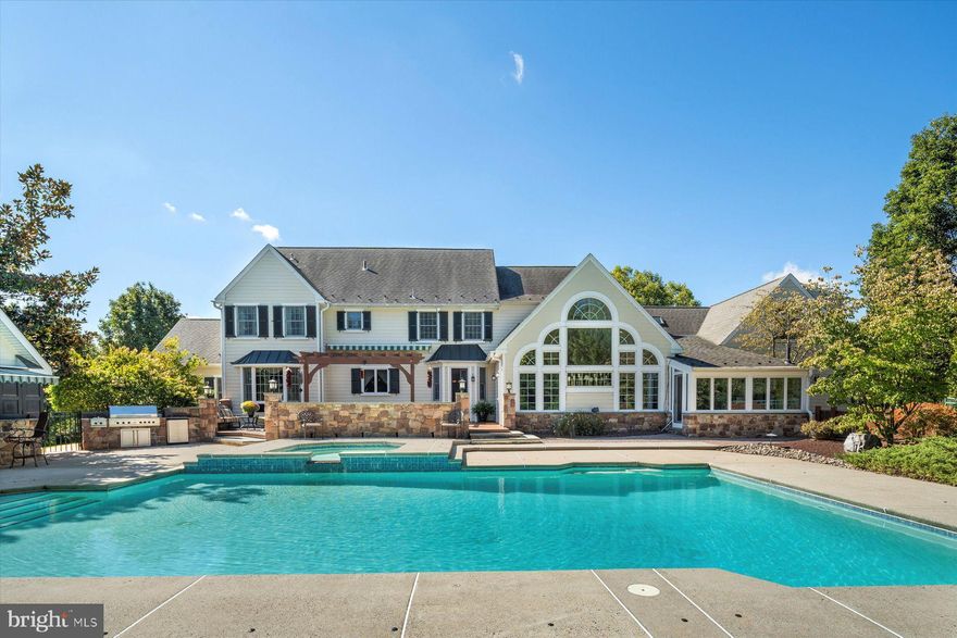 1751 Holicong Road, New Hope, PA 18938 A Home of Entertainment- is the best way to describe this beguiling 5907 sq ft home (including basement). A long tree-lined driveway directs visitors to this center hall colonial home where its cleverly designed landscaping gives you the feel of extended space and privacy. The main entrance, with its lead-crystal and ebony door and palladium window, greets guests in the formal foyer complete with hard wood flooring, chandelier and an elegant powder room. The foyer is immediately flanked by a stunning glass solarium with a castle-like stone wall and staircase, which leads guests to the home’s arcade. Formal Living Room: crown molding; recessed lighting; and hardwood floors, 9 foot ceilings, divided-light windows. Formal Dining Room: continues the crown molding: recessed lighting; and columns. Music Room: is flanked on three sides of windows and one side of interior doorways  with views of the living and dining rooms.
Library: Cherry, custom bookcases and flooring, sitting area, and French doors leading to the oversized family room with additional custom bookcases and a pellet stove for those chilly evenings, an adjacent office overlooking the pool also has a pellet stove.

Kitchen: Sparkling and new Viking refrigerator/freezer, new Wolf, propane, cooktop and new Viking  double ovens. There are granite countertops in both the kitchen and coffee bar. There are 2 wine chillers, extensive cherry cabinetry, dishwasher and breakfast area all overlooking the the pool and cabana.

Arcade: Gaming area with a built in bar, beer/wine cooler and ice maker. A 1000+ bottle capacity (climate controlled) wine cellar. Additionally, there is  a steam/sauna combination room with powder room. A large storage are is immediately adjacent to the bar area.

Primary Bedroom:  an en-suite bathroom has two pedestaled sinks on two separate walls, walk-in shower with two shower stations, a jetted soaking spa tub; Exercise room; Reading library; Two separate closets (one room sized) ; bench window seating and under storage; access view of foyer and family rooms. 
2nd Bedroom: is en-suite with front garden views.
3rd & 4th Bedrooms: Both have poolside views, large closets and share a Jack & Jill marbled bathroom with long vanity with dual sinks.

Exterior: 40,000 plus gallon pool & hyper jetted hot tub; Multi  level mahogany decks with a very large pergola and retractable awning; Cabaña with granite counters, refrigerator, ice maker,  kegerator, exterior surround sound system and access to  the pool-house storage and retractable awning; Propane Viking grill with side burners; Raised bed vegetable gardens; Bocce court; Temperature  controlled multi-outlet 20 amp shed/workshop; 3-oversized car garage; Balder (Chevy,350, 5.7 liter) whole house generator; landscape lighting; in -ground sprinkler/drip system.