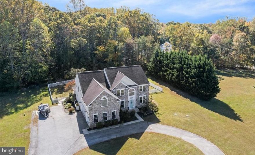 Welcome to this exceptional Huntingtown property—just in time for the holidays! Ideally located with no covenants and no HOA, this home offers outstanding flexibility and value. A circular driveway with generous parking leads to the attractive stone façade. The fenced outdoor living area features a patio, deck, and a private 16 x 32 organic edge inground pool with boulder accent and brick coping, ready to enjoy for the 2026 season. Inside, the home offers an appealing layout with an open staircase and soaring ceilings that enhance the main level and the spacious primary suite. The carpet throughout the home is brand new, and the paint is fresh, for a move-in ready offering! Upon entering the two story foyer, hardwood floors flow through the dining and formal living room into the impressive two-story family room with abundant natural light and a fireplace with pellet insert. The family room, kitchen, and sunroom/breakfast room connect seamlessly, with a custom built-in and under-counter refrigeration for easy dining and entertaining. A main-level office and also the formal living room (ideal 2nd office/playroom) add versatility.  The upper level has an overlook walkway between 4 bedrooms. The primary suite is a complete owner's domain with vaulted ceilings, a large sitting room, 2 large closets, a bathroom with jetted tub and shower + dual vanities! The walkout lower level with bath rough-in invites future finishing. Three-car garage. Thoughtfully priced, and ready to enjoy for the holidays.