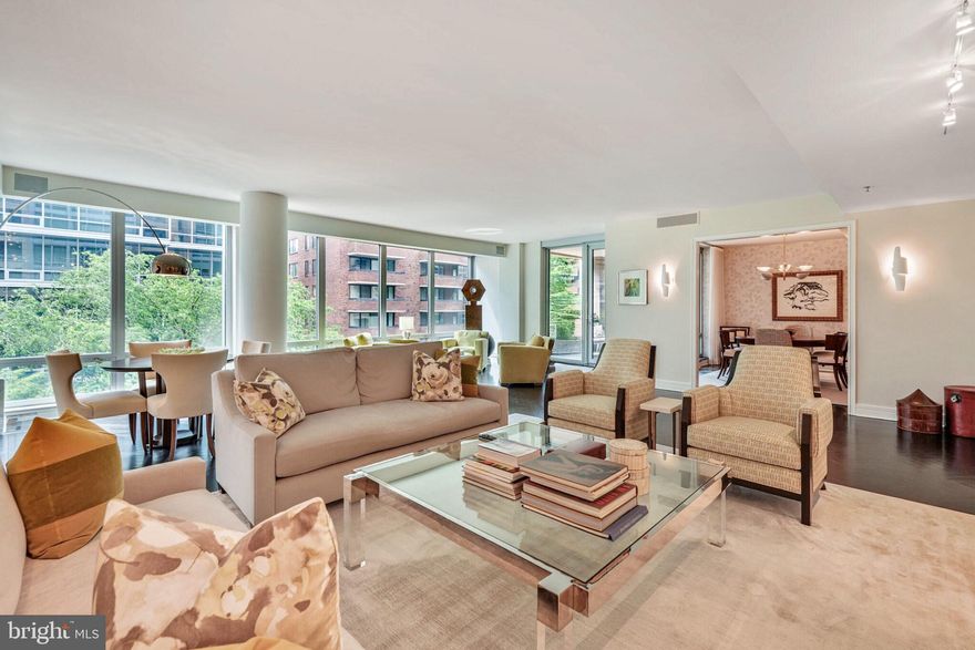 Incredible new price! Welcome to 1111 23rd St NW #4F. This exceptional residence embodies sophistication and comfort, with bespoke interiors that are both tranquil and timeless. The gracious entry hall opens to an expansive living room featuring floor to ceiling windows that capture beautiful sun-light throughout the day. With room for multiple seating areas and custom built-ins, the living room is designed for elegant living and entertaining. The spectacular dining room is adorned with designer wallpaper and provides one of two access points to the terrace. A gourmet kitchen offers top-of-the-line appliances paired with quartz countertops that will satisfy the most discerning home chef. Adjacent to the kitchen, a den with more custom built-ins awaits. The primary suite features ample closet space, a spa-like bath, and serene views of the Ritz-Carlton courtyard. A second bedroom with built-ins and ensuite bath plus two reserved parking spaces complete this exceptional offering. Unquestionably, this home provides a unique opportunity for a turnkey residence of the highest standards. Enjoy all the white glove services of the legendary Ritz-Carlton, including 24-hour concierge, doormen, porters, valet parking, security, and more. The West End location provide an abundance of conveniences with numerous top restaurants, health clubs, grocery stores and is within easy distance to Georgetown and the Kennedy Center.