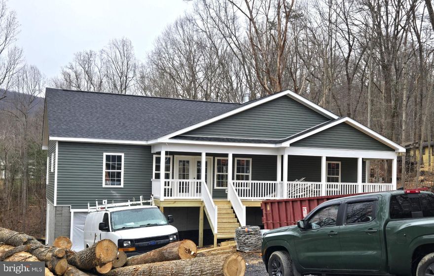 NEW CONSTRUCTION.   Home is able to be permitted for a air B&B through the county. 3 beds 2 full baths. 4 bedroom conditional 6 person septic. 2 car garage in the basement. unfinished basement with full bath rough in. If finished basement is desired for additional $45,000. builder will complete a fourth bedroom with a full bath and a rec room adding an additional 1120sqft. home has concrete driveway. Home is located in Shenandoah Farms which has lake access and two private boat landings for river access.  PICTURES are similar to