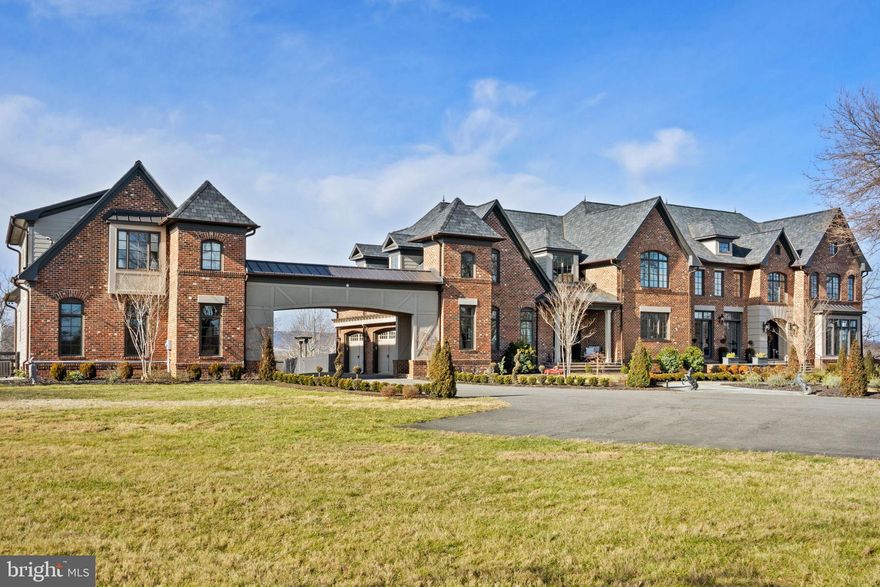 Welcome to Belvedere — A Legendary Middleburg Estate of Distinction and Unmatched Privacy
Perched majestically in the countryside with sweeping panoramic views of the Blue Ridge Mountains, this extraordinary gated estate offers an unparalleled country lifestyle just minutes from historic downtown Middleburg. Spanning approximately 27.53 serene acres, 21051 St Louis Rd embodies timeless elegance, exquisite craftsmanship, and modern luxury — a truly singular property for the most discerning buyer.
As you approach through commanding stone pillars, a sweeping paved driveway, and classic four-board black fencing, you are greeted by an atmosphere of refined grandeur. The landscaped grounds feature lush pastures, mature ornamental plantings, newly added perimeter and cross fencing, and multiple outdoor living areas including a charming pergola and expansive terraces that frame unforgettable views.
This exceptional residence — designed by respected architect James MacDonald of the Lessard Group and built by University Homes — is acclaimed for its architectural integrity and superior construction quality. Every detail has been thoughtfully designed and executed, including interior accents, Brazilian cherry hardwood floors on the main level, updated lighting, and more.
Boasting over 8,400 square feet of meticulously finished living space with a thoughtful, light-filled plan, the estate includes formal and informal entertaining rooms ideal for both grand affairs and intimate gatherings. High ceilings, elegant crown moldings, dual staircases, and expansive windows create an atmosphere of effortless sophistication.
The gourmet chef’s kitchen is a showpiece of culinary design — anchored by Cambria quartz countertops, a striking tile backsplash, top-tier Wolf appliances including commercial-grade range and double ovens, an oversized island, custom cabinetry, and adjoining butler’s pantry — delivering both style and functionality for entertaining at any scale.
Flowing gracefully from the kitchen, the great room and formal dining spaces provide picturesque views of the estate’s sprawling lawn, ideal for indoor-outdoor living and hosting seasonal events. A vaulted, screened porch offers a peaceful retreat to savor morning coffee or evening sunsets against a backdrop of rolling countryside.
The luxurious Owner’s Suite is a private haven, fully remodeled with spa-inspired bath finishes, bespoke lighting, refined plumbing fixtures, premium tile work, and serene natural light. Additional bedrooms offer generous proportions, abundant closet space, and thoughtfully designed baths.
A remarkable feature of this estate is the attached carriage house, connected by a covered breezeway and providing complete privacy for guests or extended family. This well-appointed space includes a full kitchen, living and dining area, a bedroom suite with walk-in closet, and a one-car garage, making it ideal for visitors or as a separate income-producing quarters.
Beyond its beautiful interiors, this estate delivers functionality and comfort with a four-car attached garage, full basement with walkout access, central vacuum, security system, extensive hardscape patios, and underground utilities. The land, zoned AR2, is fully fenced and can easily accommodate horses, livestock, gardens, or other country pursuits.
Belvedere’s location strikes an exceptional balance — offering complete privacy and tranquility while remaining moments from the cultural richness of downtown Middleburg’s fine dining, specialty shops, art galleries, equestrian facilities, and community events. This is a rare opportunity to own a signature estate that embodies the very essence of Virginia countryside living at its highest level.

Experience luxury, privacy, and panoramic beauty!

No Drive By's.