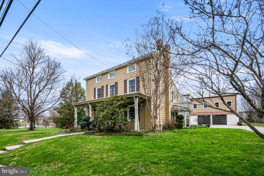 This stunning 4-bedroom,  3-bath farmhouse blends timeless character with thoughtful updates and versatile living space, all set on nearly an acre.
At the heart of the home is an impressive chef’s kitchen featuring granite countertops, stainless steel appliances, and a custom wraparound island with seating for six or more,  perfect for gathering and entertaining. Just off the kitchen, a bright sunroom/den offers views of the neighboring pond and French doors leading to the patio and fully fenced backyard.
The first floor also features a welcoming living room with fireplace, a spacious dining room, newly renovated full bath and laundry room.  Beautiful original hardwood floors run throughout much of the home, complemented by custom built-in shelving and cabinetry and original deep window sills with newer replacement windows. Statement light fixtures in the kitchen and dining room create stylish focal points while blending seamlessly with the home’s historic character.
Upstairs, the spacious primary bedroom includes an ensuite bath. Two additional bright and charming bedrooms and a third full bath complete the second floor,  with ample closet space throughout.
The third floor offers additional versatility with a fourth bedroom and another finished room that could serve as a fifth bedroom,  home office,  or studio. Skylights, generous windows with deep sills perfect for cozy window seats, and a distinctive geometric painted floor give the space unique character.
Outside, the fully fenced yard includes a play area, large raised garden beds, mature fruit trees, and an arbor with established grape vines, creating an ideal setting for gardening and outdoor enjoyment.
A large multi-level bank barn is a standout feature of the property, offering a screened aviary with indoor brooding room for poultry, ample workshop space, and an expansive upper level with exceptional ceiling height that presents outstanding potential for expanded indoor recreation space, studio or gym use, or other creative possibilities.
Connected to the barn is an oversized two-car garage with 9-foot ceilings and a second-story loft that could be finished into office space or additional workspace. Together,  the barn and garage provide exceptional space and versatility and may offer potential for a small business if permitted by the township (buyer to verify).
Some of the most noteworthy improvements include a standing seam metal roof installed in 2018,  new siding and windows on the garage in 2021, newly installed dishwasher and range in 2026, and fresh interior and exterior paint.