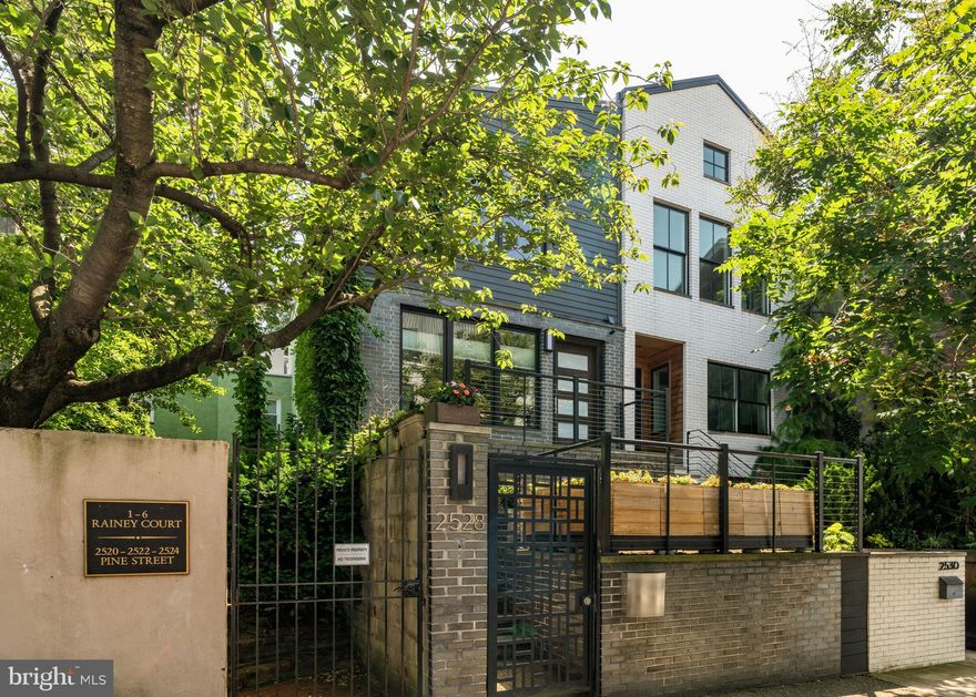 Welcome to 2528 Pine Street in Fitler Square. This thoughtfully redesigned, one-of-a-kind 3-bedroom townhouse with garage parking sits on an 84 ft deep lot, offering a peaceful retreat. Architecturally distinctive and reminiscent of classic San Francisco design, this residence is set back and elevated from the street, blending timeless character, modern amenities, charm and privacy — a rare offering that truly stands apart.

A gate welcomes you through the front garden and patio to the front steps and entrance. The main living area is bathed in natural light, thanks to windows on three sides with southern, eastern, and northern exposures, and showcases beautiful white oak hardwood floors.

The open-concept living and dining rooms are anchored by a wood-burning fireplace with a marble surround and a built-in bar. Just off the dining area, the eat-in kitchen boasts marble countertops and backsplash, premium appliances including a vented hood over the six-burner stove, and custom cabinetry.

The primary suite on the top floor is truly spectacular, featuring soaring ceilings and a picture window framing treetop and skyline vistas, along with a wall of customized closets. The en-suite primary bathroom includes marble tiling, a generous pedestal sink, and a seamless glass-enclosed dual shower.

A mirrored door discreetly hides a conveniently placed laundry room equipped with a full-size washer and dryer plus extra storage. Also on the top level is a second bedroom and a beautifully appointed hall bath with a tub/shower combination and an oversized single-sink vanity.

The lower level is at garden height and offers another generous bedroom, a cozy flex space, a full bathroom with a walk-in shower, and access to both the mudroom and garage.

At the rear of the home behind the garage, you'll find room for a 2nd vehicle and access to a semi-private driveway that leads to 26th street.

2528 Pine Street is ideally located in the heart of Fitler Square, directly next to Schuylkill River Park, which offers community tennis courts, trails for jogging, biking and walking, a dog park, community gardens, and the Markward playground.

Within just a few blocks, you'll enjoy neighborhood favorites like Rowhome Coffee, Rival Bros, Ambrosia, Sallys, and Trattoria Carina, as well as everyday conveniences such as Heirloom Market, CVS, and Weekend Farmers markets just up the street.

This home is also a quick commute to CHOP, Penn, HUP, Drexel, and 30th Street Station. With its unmistakable design and rare architectural presence, this is a property you’ll truly love to call home.