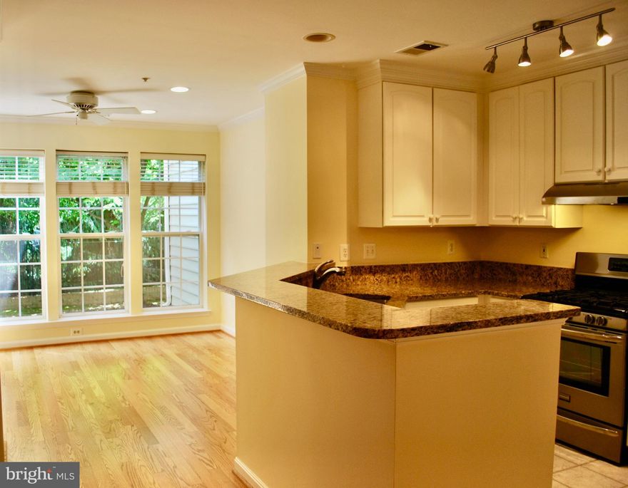 2 lvl townhouse condo, open floor plan, bump-out window in living rm w/ sunlight beaming thru big windows on main & upper lvls, HWD flrs, renovated kitchen w/ breakfast bar, stainless steel appliances, granite counter tops, pantry, kitchen opens to family rm w/ gas fireplace, crown molding, ceiling fan, built-ins; sliding glass doors to patio & small yard, 1/2 bath on main lvl.  Upper lvl laundry room, Fabulous primary bedroom suite w/ large walk-in closet, ceiling fan & renovated bath w/ granite counter tops, double sinks, separate frameless shower & large soaking tub.  1 assigned parking space, plenty of unassigned parking spaces & guest parking.  Walk to METRO, Whole Foods & shops!