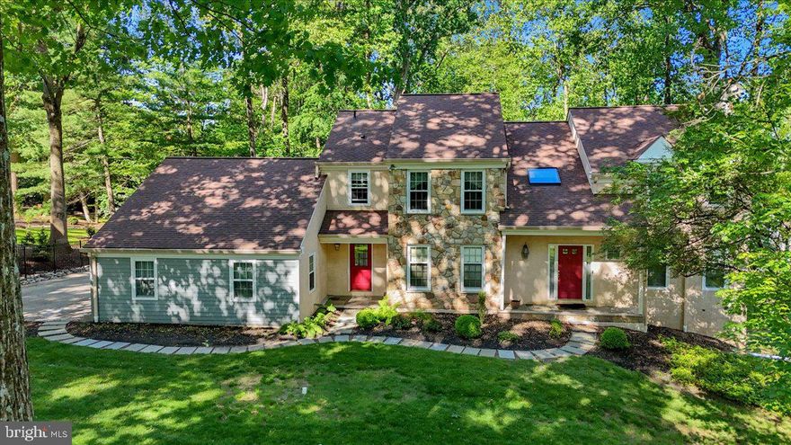 Welcome to 586 Berwyn Baptist Church Road — a timeless and refined residence in the heart of Devon, blending elegant architecture, flexible living spaces, and an unbeatable Main Line location just moments from Jenkins Arboretum.

Set on a private, tree-lined lot in the award-winning Tredyffrin-Easttown School District, this 4-bedroom, 2.5-bath luxury home offers over 4,300 square feet of living space, including a 999 sq ft finished lower level, a 3-car garage, and a layout designed for both relaxed living and sophisticated entertaining.

The grand entrance sets the tone: a two-story foyer with soaring 16-foot ceilings and rich hardwood floors flows into a formal dining room adorned with crown molding and chair rail, and a sunken living room with a wood-burning fireplace—perfect for hosting guests or enjoying quiet evenings.

The updated gourmet kitchen is a true centerpiece, featuring granite countertops, double sinks, stainless steel refrigerator and dishwasher, and a bright breakfast area. It opens directly to the spacious family room, which offers a second wood-burning fireplace, built-in wet bar, and access to the expansive deck—ideal for entertaining indoors and out.

A dedicated home office on the main floor includes hardwood flooring and direct access to a peaceful enclosed sunporch—a rare and serene space to work or unwind. The first-floor laundry room adds everyday convenience.

Upstairs, the luxurious primary suite delivers a true retreat, complete with a walk-in closet, sitting area, and a renovated en suite bath featuring a frameless glass walk-in shower, soaking tub, double vanity, and heated floors—an indulgent touch that elevates your daily routine. The updated hall bath also includes double sinks and ample cabinetry, serving the three additional bedrooms with ease.

The finished lower level adds versatility with a home office or bonus room, recreation/media area, and Bilco door access to the backyard. An unfinished section offers generous storage or workshop space.

The exterior is equally impressive, with stone, stucco, and Hardie board siding, mature landscaping, and a large deck for outdoor living—all in a quiet, walkable neighborhood setting.

Enjoy proximity to Jenkins Arboretum & Gardens, a 48-acre botanical sanctuary open year-round. Just minutes from the home, this beloved local treasure offers wooded walking trails, vibrant seasonal plantings, and peaceful views—an exceptional amenity for nature lovers and a true extension of the lifestyle offered here.
