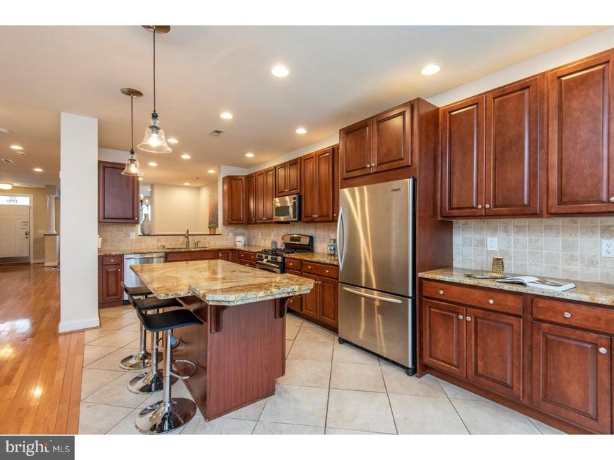 Stop what you're doing, and take a look at 1616 Green Street! Featuring 4 beds, 4.5 baths, a huge 2 car garage with access to an additional 3rd space in the easement right outside the garage, and over 5,000 square feet of living space including multiple outdoor entertaining spaces and an in-law suite with an additional full bathroom; prepare to fall in love. The open layout of the first floor makes entertaining a dream, so be ready to host many holidays and parties. The formal living and dining room flow back to the spacious kitchen, which features solid wood cabinetry, stainless steel appliances, granite counters, and a massive center island where everyone is sure to gather. Off the rear of the main floor is a large patio for grilling and dining al fresco . On the second floor, you'll find two bedrooms, both with ample closet space and private, en suite bathrooms. Up another flight is the sumptuous master suite, that will provide you with a true retreat. With a large bedroom, sitting area, over-sized closets, and a spa-like bathroom, you'll never want to leave. But keep exploring, because the best is yet to come. Continue up to check out the massive roof deck; the largest in the community. Complete with a built-in outdoor kitchen, seating area and dining area, it may be hard to believe, but there's even room for a hammock! Pretend you haven't already fallen in love with this house, and take a peak at the basement, which was designed by the current owners. A gas fireplace, full wet bar, and full bathroom take care of all your creature comforts. In addition to all of this, there's an in-law suite over the garage. Just when you're thinking this can't possibly get any better, wait until you discover the location. Within walking distance of St. Stephen's Green, where you can get one of the best burgers Philly has to offer, as well as Osteria for some amazing Italian food, all that Philadelphia has to offer will be at your fingertips. Don't miss your chance to call 1616 Green Street your new home, schedule your showing today! Property is part of the Spring Garden Historic District.