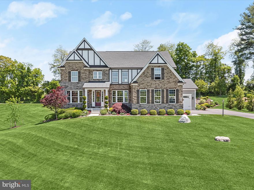Nestled within the Fairlane Farm neighborhood, this exquisite four bedroom home sits on a pristine 1.11-acre lot, offering a tranquil escape. Built in 2018, this Radford model by NV Homes spans over 6,400 square feet across three levels, promising luxury and comfort at every turn. Approaching the home, a long driveway leads to your new sanctuary, surrounded by impeccably manicured grounds and landscaping. Step inside to discover a haven flooded with natural light and adorned with a neutral color palette. The foyer welcomes you with gleaming hardwood floors that extend throughout the main level. A cozy front living room invites relaxation, while the elegant dining room sets the stage for memorable gatherings. Unwind in the family room, featuring a soaring two-story coffered ceiling and stone fireplace. The gourmet kitchen is a chef's dream, boasting granite countertops, a tile backsplash, soft-close cabinets with under-cabinet lighting, a pantry, a spacious center island with a breakfast bar, and stainless steel appliances. Adjacent to the kitchen, the breakfast nook offers a casual dining space. Escape to the enclosed sunroom, equipped with a mini-split system for year-round comfort, and enjoy the serene surroundings accompanied by the soothing sound of the pond and waterfall. The main level also includes an office and a half bathroom. Upstairs, the luxurious primary bedroom suite awaits, featuring a tray ceiling, dual walk-in closets, and a spa-like ensuite bathroom with two vanities, a soaking tub, and an oversized walk-in shower. The upper level also features a convenient laundry room with storage. A second bedroom suite with a private bathroom and two additional bedrooms with a connected bathroom complete this level. The expansive lower level presents endless possibilities and awaits your personal finishing touches, with walk-out doors leading to the patio and a large storage shed. This peaceful setting backing to trees creates the perfect backdrop for enjoying time both inside and outside. Additional features of this remarkable home include an indoor and outdoor security system, zoned energy-efficient heating and cooling systems, a reverse osmosis system for the kitchen refrigerator and instant hot water dispenser, landscape up-lighting around the house and trees, and a yard irrigation system with holding tanks. The attached garages offer space for three vehicles with additional storage.