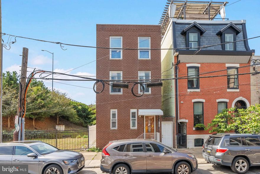 Modern updates, private outdoor space, and a walk-to-everything location make 1030 Marlborough St a standout in the heart of Fishtown. This spacious 3-story detached home offers 3 bedrooms, 1.5 bathrooms, a back patio, and a roof deck off the third floor. A low-traffic block leads to the towering brick facade. Inside, gleaming hardwood floors stretch across the airy living room, where there's plenty of space to hang out and entertain. Crown molding that traces the tall ceilings, built-in shelving, and an intricate banister add character. Through a curved archway, the dining room features a pair of sunny windows, a ceiling fan, chair rail along the walls, and a convenient half bathroom. A highlight of the property is the bright, eat-in kitchen fitted with stainless steel appliances, custom cabinetry, black counters and a coordinating backsplash, a laundry closet with pantry storage, and extra space for a rolling cart. Out back, there's a large private patio, rarely found in the city. It's the perfect spot for barbecues, gardening, and al fresco dining, plus a breezeway entrance from the street provides easy access for guests. Up on the second level, off the staircase, is an open flex space that could be used as an office or workout area. A pair of sunlit bedrooms, with hardwood floors and generous closets, are on opposite ends, flanking a full bathroom. The top level is dedicated to a huge, third bedroom with tons of natural light and access to the roof deck. Completing the home is a clean, dry basement offering extra storage. 1030 Marlborough St's prime Fishtown location is only steps from Girard Ave and Frankford Ave, with endless restaurants, local shops, and nightlife to enjoy. Penn Treaty Park, Rivers Casino, The Fillmore and Northern Liberties are nearby, along with easy access to public transit, I-95, and South Jersey. Schedule your showing today!