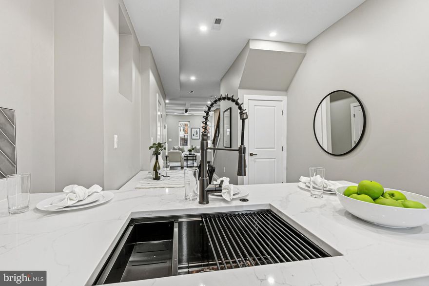 Price Improvement — One of the Best Values for a Fully Renovated Home in the Area

Now offered at $279,900, 2906 Clifton Ave presents an exceptional opportunity to own a fully renovated Baltimore rowhome at a price rarely seen for this level of finish and craftsmanship.

Thoughtfully renovated by APG Design Build, this home offers modern design, quality workmanship, and fully permitted improvements throughout. The open main level features warm flooring, recessed lighting, and a stunning kitchen with quartz countertops, a waterfall peninsula, brushed black nickel hardware, stainless steel appliances, and a striking herringbone backsplash.

Step directly from the kitchen onto the rear deck overlooking the fully fenced backyard, creating an ideal space for relaxing or entertaining. Upstairs, spacious bedrooms and contemporary bathrooms feature clean, modern finishes and LED mirrors. The fully finished basement provides valuable additional living space with a convenient rear walk-out to the yard.

Major systems including HVAC, plumbing, and electrical have been updated as part of the permitted renovation by APG Design Build.

Eligible buyers may qualify for several Baltimore City and Maryland down-payment assistance programs, including Vacants to Value (V2V), Live Near Your Work (LNYW), Baltimore City employee incentives, and Maryland Mortgage Program options — potentially reducing the amount needed to purchase.

With its new price and move-in ready condition, buyers looking for value will want to see this one quickly.