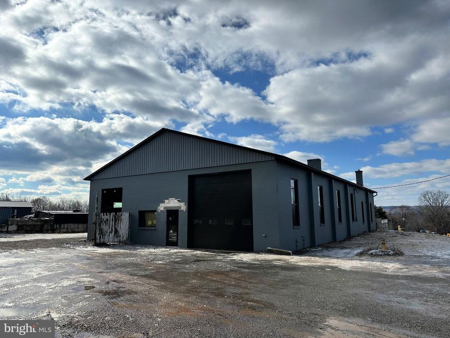 Building has been renovated 2024/2025.  New roof, new windows, new overhead doors.  New natural gas heating system to be installed.  Owner plans to add an office space and another bathroom and will do this with input from new tenant.  Also ceiling to be installed with LED lights and interior walls will be painted. Nice open span space with the opportunity to work on large trucks.  Call for details.