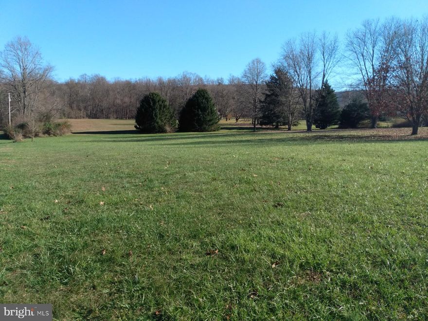Excellent building lot just 1/2 mile from Great Cacapon, level and in grass with a distant mountain view, public sewer. This is the perfect spot for your new home, it's unrestricted land so your choices of construction are endless. Near the Cacapon and Potomac Rivers.   Priced to sell so come take a look today.