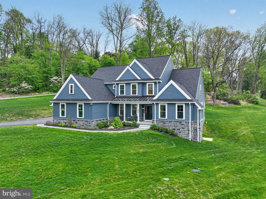 Set on almost 3 breathtaking acres in highly desirable Middletown Township, this exceptional custom-built home (built in 2023) offers the perfect blend of luxury, privacy, and timeless design. Perched gracefully atop a gentle hill, the property boasts stunning curb appeal and sweeping views of neighboring farms and serene ponds, creating a picturesque, estate-like setting.

The welcoming front porch is ideal for rocking chairs and quiet mornings. Inside, you’re greeted by a sun-drenched home office featuring expansive windows and generous closet storage, offering an inspiring work-from-home retreat. The formal dining room sits just off the entry, perfectly sized for hosting holidays and special gatherings.

The impressive two-story foyer flows seamlessly into a dramatic two-story family room, where large windows frame the scenic landscape and flood the space with natural light. A striking double-sided fireplace connects the family room to the heart of the home; the chef’s kitchen and breakfast area.

Designed for both everyday living and entertaining, the gourmet kitchen features GE Profile appliances, custom Century Kitchens cabinetry, a large center island, double ovens, and a statement hood vent. A stunning herringbone backsplash extends from the range to the ceiling, adding a sophisticated design element. Just beyond, doors lead to the patio and backyard, offering endless possibilities for outdoor living—with additional space to clear for even more usable land if desired.

Convenience meets functionality with a well-appointed mudroom and powder room located just off the kitchen, providing easy access to the three-car garage.

The first-floor primary suite is a true retreat, showcasing peaceful pond views, abundant natural light, a spacious custom-outfitted walk-in closet, and a luxurious en-suite bath with dual vanities and an oversized walk-in shower.

Upstairs, a thoughtfully designed layout includes a private “mini primary” suite with its own bath, two additional generously sized bedrooms connected by a Jack-and-Jill bathroom, and a versatile fifth room, ideal as a bedroom, playroom, or additional living space.

The walk-out basement offers incredible potential, already framed by natural light and scenic views, and ready to be finished to suit your vision whether it’s a home theater, gym, bar, or additional living quarters.

Additional highlights include luxury vinyl plank flooring throughout, a whole-house generator, a three-car garage with epoxy flooring, motorized window treatments, dimmable recessed lighting, a water softener system, and a full security system with cameras and remote access. A 12x20 shed sits on the other side of the driveway making it a convenient place to store lansdscaping tools, toys, etc. The roof and siding are both under transferable warranties, providing added peace of mind.

This is a rare opportunity to own a nearly new, thoughtfully designed luxury home in a truly idyllic setting, offering space, sophistication, and unmatched views.