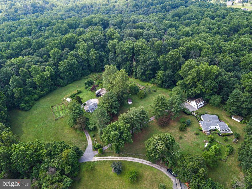 Amazing opportunity to own 10+ acres in Windsor Mill!  This property is made up of 3 parcels with 4 dwelling units totaling more than 5,000 finished sf, multiple outbuildings, and beautiful chapel.  The main house has 1,859 square feet above grade plus a finished basement.  It offers 4 bedrooms, 2.5 baths, a beautiful sunroom addition, plenty of storage, and brand new carpet.  The main garage has room for 2 cars plus storage and additional covered parking plus an upper level apartment with 1 bedroom, 1 full bathroom, kitchen, and living room.  The farmhouse at the front of the property (8617) is 1,152 square feet and has 2 bedrooms and 1.5 baths.  There is also another dwelling with 1 bedroom, 1 bathroom, and kitchen.  Venture through the woods to the back of the property to find the gorgeous Tersiguel Memorial Chapel.   Nature lovers will enjoy this picturesque property with numerous raised garden beds and ample wooded area.   Opportunity abounds for multigenerational living, Air B&B hosting, homesteading, and more!  This property is a rare gem and you must see it to appreciate how much it has to offer!  See disclosures for the three tax records that all convey with this sale.