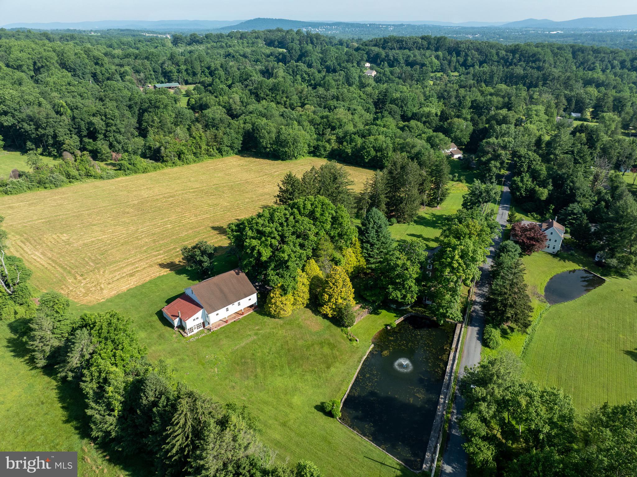 Welcome to 1453 Coldsprings Road, a charming 1880's stone home on a quiet road in Northern Chester County. This home has 5 bedrooms (with a potential 6th bedroom) and 2.5 bath with 3000+ square feet. The house, large bank barn and detached garage are situated on a 8.9 acres of unrestricted ground. The home features hardwood floors in the original 1880's part of the house, an abundance of natural light, and inviting views of the property. The first floor has an easy flow; family room, sun room, kitchen, dining/family room and formal living room. The laundry room, also off the kitchen, leads to the powder room and a back door towards the pond.. The second floor has 5 bedrooms, and two full bathrooms. Outside there is a lovely spring fed pond, large yard, and 5 + acres of fields. The property features a large bank barn that formally kept sheep but has the potential to keep other livestock! This property has many possibilities and hours of endless fun for everyone. Start your dream farmette with animals and gardens/agriculture, or enjoy as a peaceful summer home. Coldsprings Farm has it all!