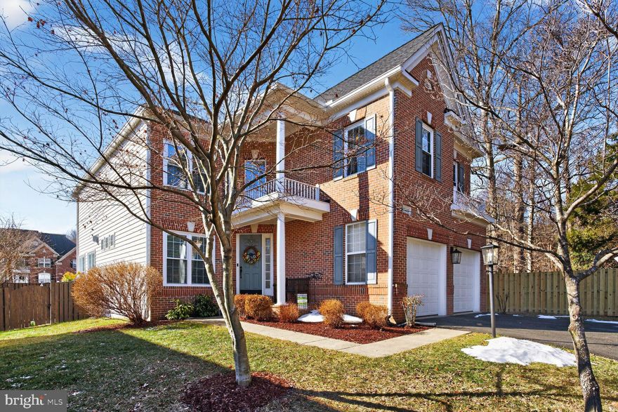 Welcome to 9540 5th Place, a fantastic Birchstone model with a 2-car garage, ideally situated on a quiet street in Lorton’s desirable Village at Lorton Valley. The handsome covered front porch and classic pillars give this brick-front, 4-bedroom home outstanding curb appeal. This stunning colonial offers over 4,000 sq. ft. of living space with soaring high ceilings and recessed lighting throughout. The home has been freshly painted, and gleaming hardwood floors flow through the main level. As you enter, you are greeted by the grand 2-story foyer and a beautiful winding stairwell leading to the upper level. The many windows with new 2-inch faux wood blinds fill the space with natural light, while elegant crown molding enhances the office, dining, and living rooms. Classic chair rail and wainscoting add a touch of class to the dining room, and working from home is effortless in the lovely office. The bright living room is lined with windows and features a cozy fireplace with a ceramic tile surround and detailed wood mantel. Your inner chef will love the gorgeously updated kitchen, which boasts granite countertops, stainless appliances, a double oven, and a useful island with a cooktop and barstool overhang beneath chic pendant lights. Step out to the terrific composite deck with stairs leading down to the stone patio in the private backyard—a perfect space for entertaining family and friends. Upstairs are four generously sized bedrooms, all equipped with ceiling fans and roomy closets. The expansive owner’s suite includes two walk-in closets, a sitting room, and a modern 2-sided fireplace. Just off the sitting room is the spa-like ensuite bath featuring two vanities, a modern freestanding soaking tub, floor-to-ceiling shower tile, and a rainforest showerhead. The lower level offers a storage room and a bonus room with its own ensuite bath, ideal for out-of-town guests. There is also space for a home gym, and the spacious rec room includes an impressive wet bar—perfect for entertaining. Some of the many upgrades include a renovated owner’s suite bathroom (2022), refinished downstairs bar (2025), Tesla charger installation (2023), replaced windows (2018/2023), new roof (2021), and HVAC replacements for the upper unit (2018) and main-level unit (2021). Lorton Valley residents enjoy an outdoor swimming pool, a well-equipped community center with a gym and large party room, a basketball and sports court, and multiple tot lots. Conveniently located minutes from I-95, the VRE, the Lorton Marketplace, Laurel Hill Golf Club, and the Workhouse Arts Center. This home has it all!